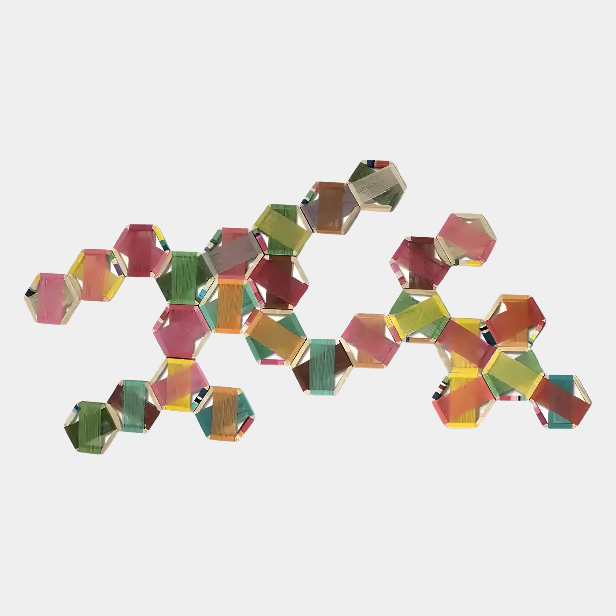 The Spectra I Multicoloured Interwoven Hexagonal Frame 3D Wall Art by Giant Sculptures features translucent green, pink, yellow, and orange hexagons forming an abstract, interconnected display on a plain white background.