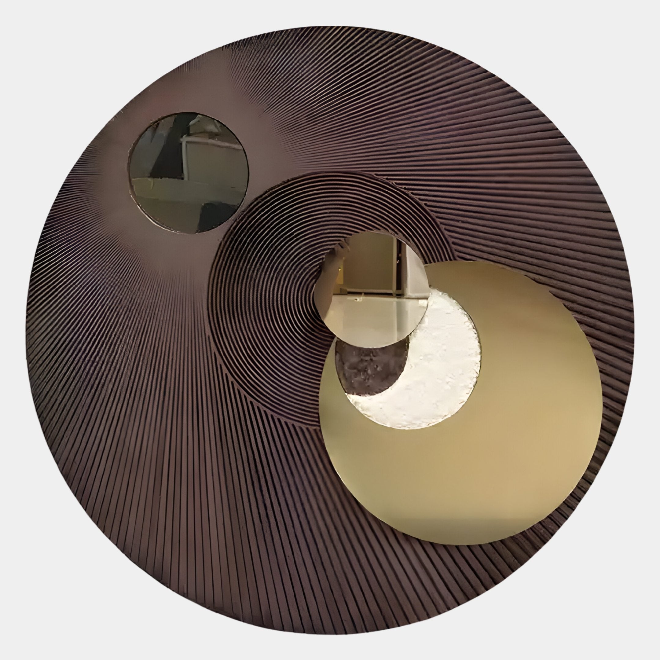The Orbitra Bronze Reflective Circular 3D Wall Art by Giant Sculptures features a dark, textured surface with radiating lines and mirrored sections—perfect as modern wall decor to add flair to any room.