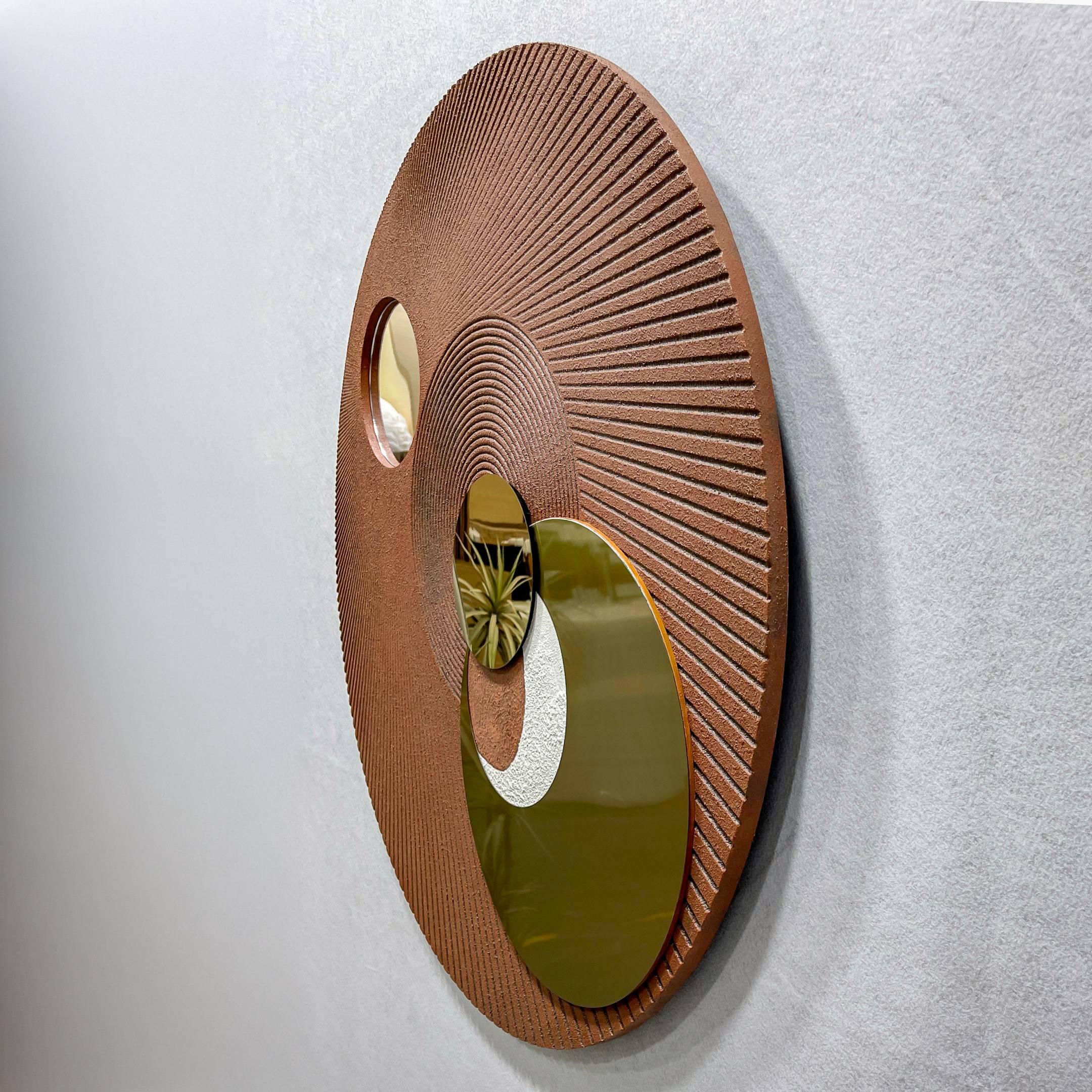 Angled side view of the Orbitra Copper Reflective Circular 3D Wall Art by Giant Sculptures, showing three polished copper-toned mirrored discs set into a textured brown ribbed panel on a light wall.