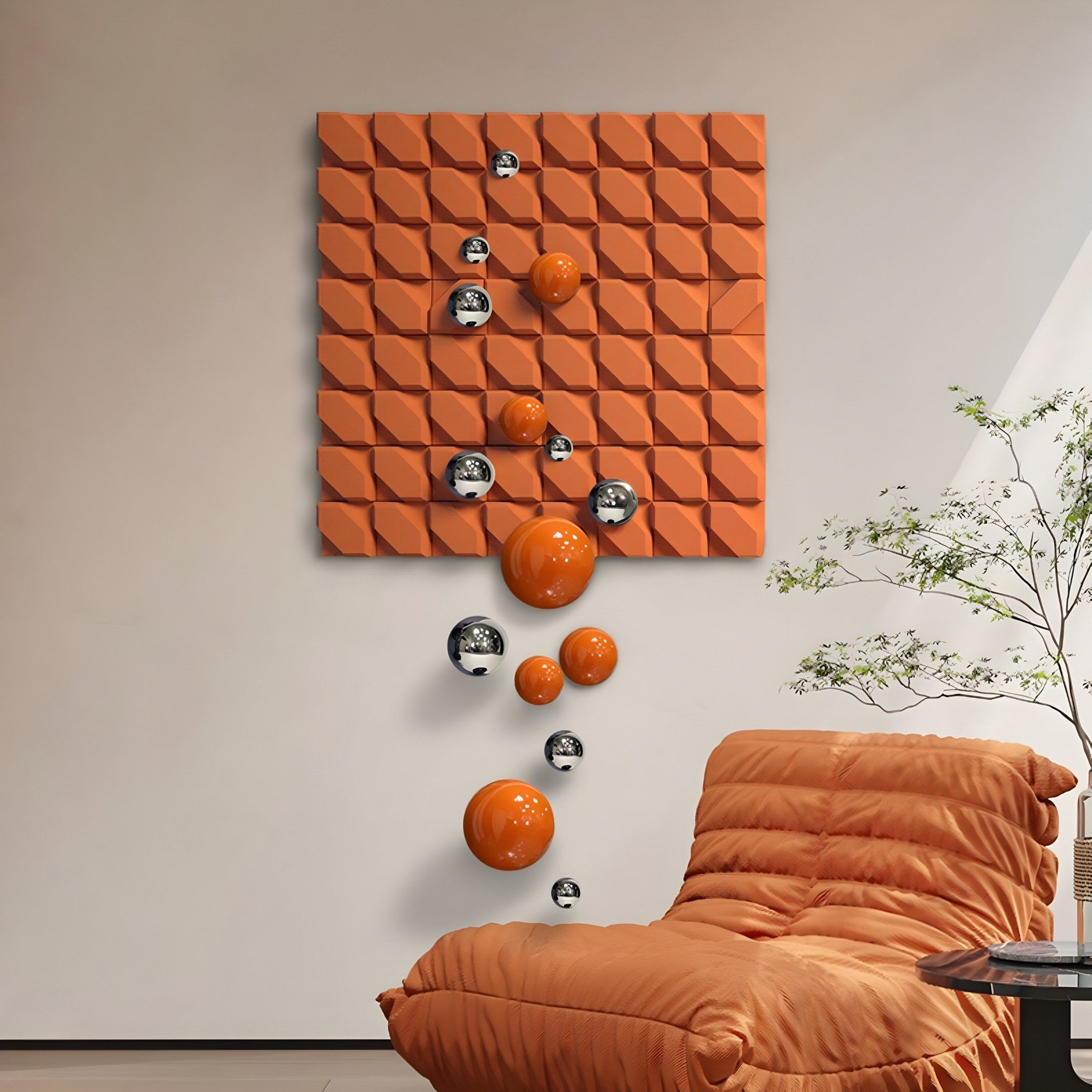 The Giant Sculptures Orbina Orange 3D Wood Relief Wall Art With Metal Ball captivates above a matching orange chair, aligning reflective metal accents and vertical orange spheres, while a small potted plant nearby adds a natural touch.