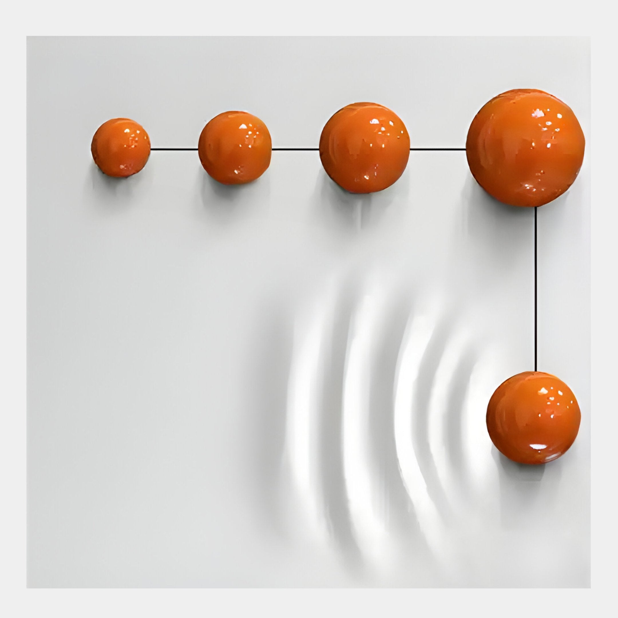 Five glossy orange metal balls form an L-shape on a white wood relief panel, connected by thin black lines. The largest ball creates ripples, making the Galactica 3D Wall Art by Giant Sculptures ideal for modern or minimalist decor.