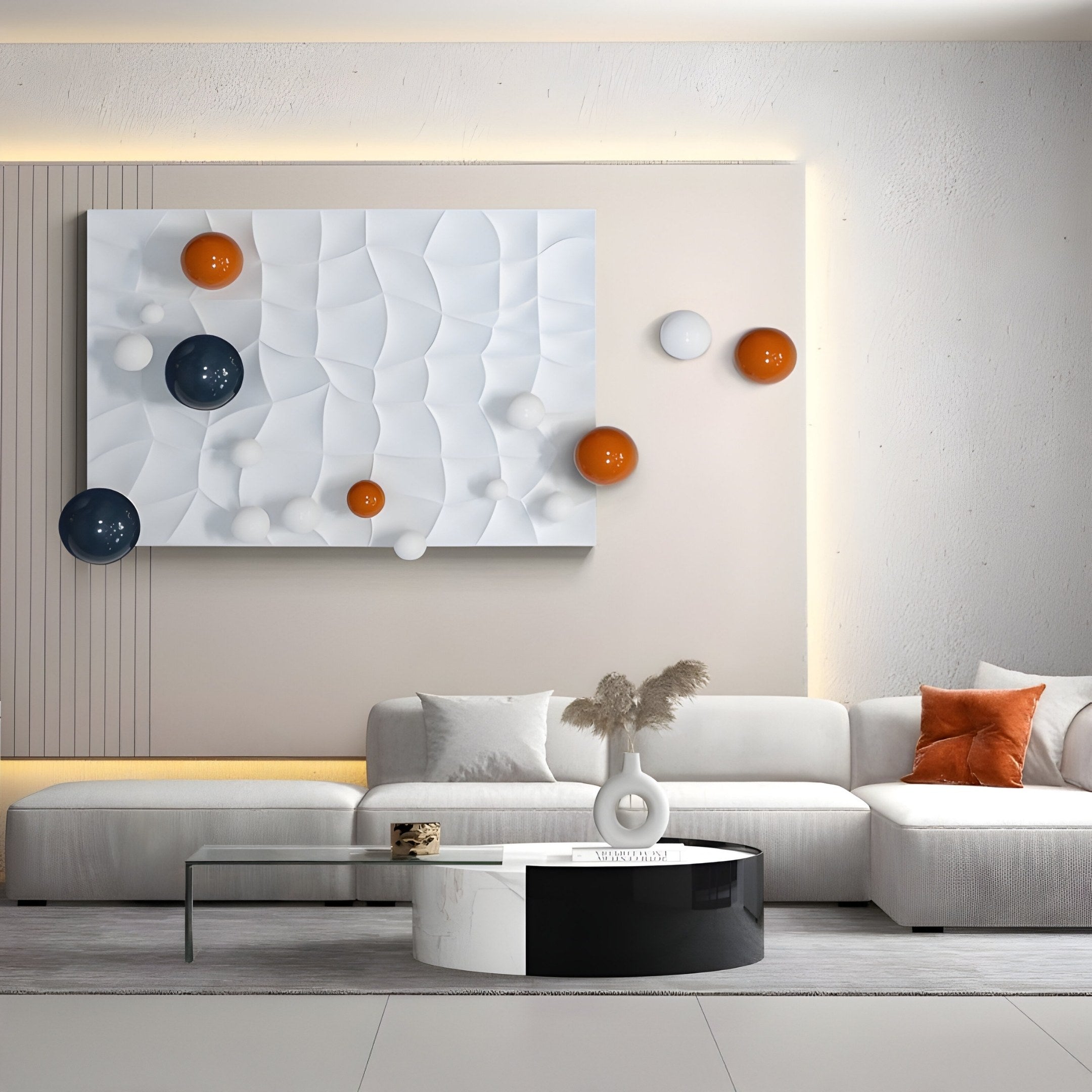 A modern living room showcases a white sectional sofa with orange pillows, complemented by the Orbison White 3D Wood Relief Wall Art With Floating Metal Ball by Giant Sculptures, featuring geometric shapes in orange, navy, and white. A round coffee table and decorative vase complete the stylish look.