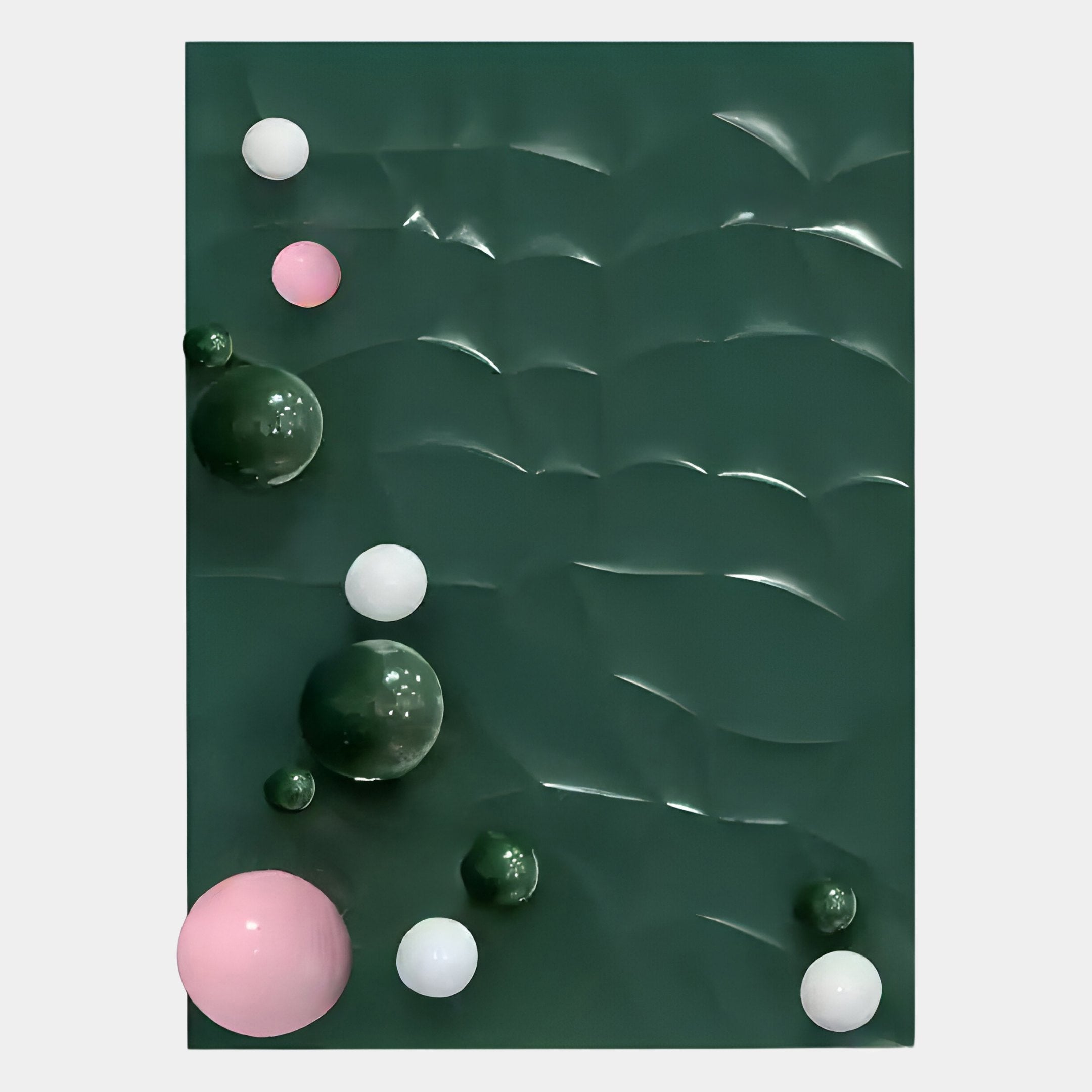 The Orbison Green 3D Wood Relief Wall Art With Metal Ball by Giant Sculptures features a dark green wavy background accented with glossy pink, white, and dark green metal spheres—an ideal contemporary décor piece for any room.