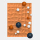 The Orbison Terracotta 3D Wood Relief Wall Art With Metal Ball by Giant Sculptures features a textured orange background with raised wavy patterns and glossy blue, orange, and white metal spheres on the terracotta surface.