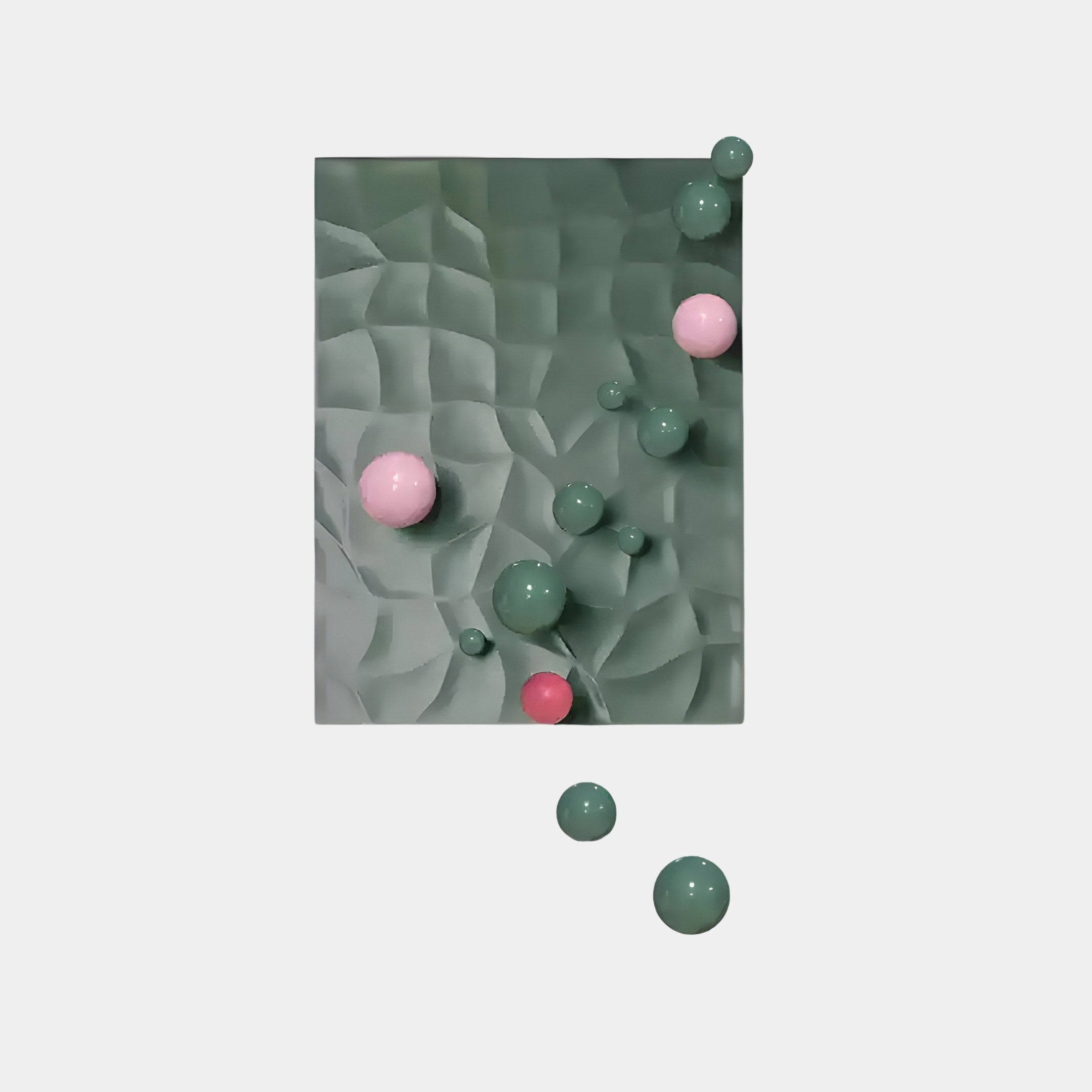 The Orbison Sage Green 3D Wood Relief Wall Art by Giant Sculptures features an abstract design with pink and green glossy spheres of various sizes, set against a textured sage green rectangle on a white background.