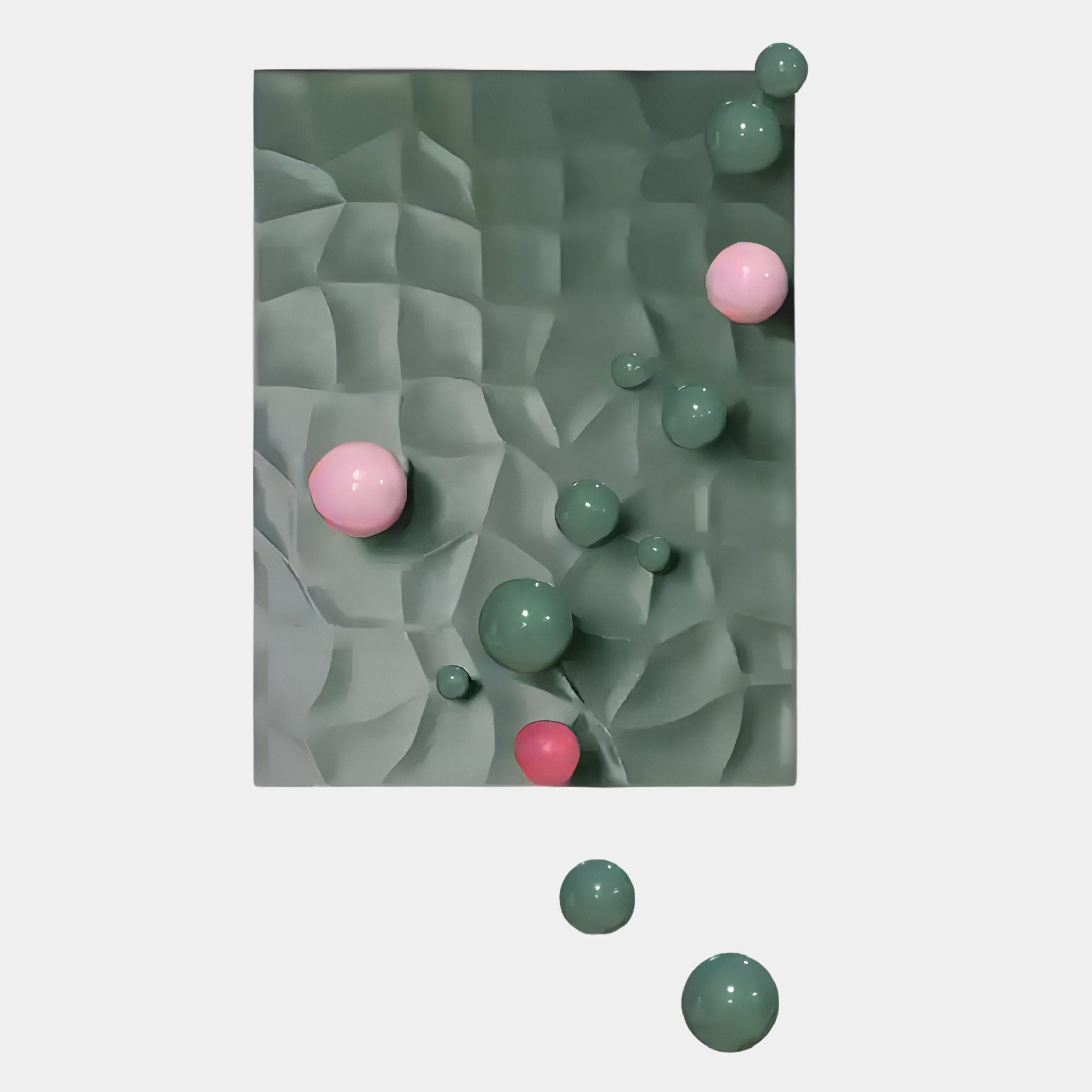 A green, textured rectangular surface with raised wavy grids recalls Giant Sculptures Orbison Sage Green 3D Wood Relief Wall Art With Floating Metal Ball, accented by glossy green and pink spheres—some extending past the lower edge onto a white background.