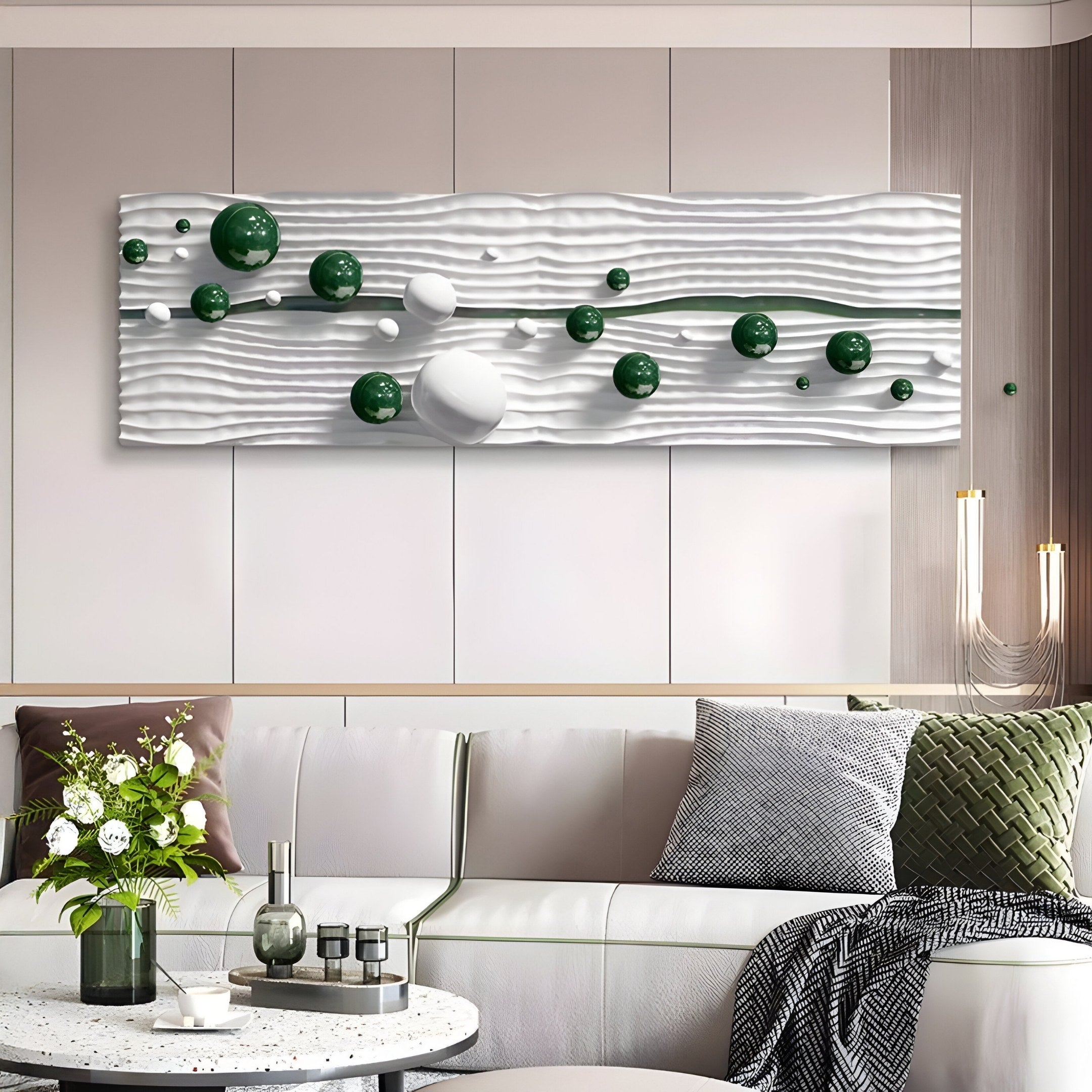 A modern living room showcases minimalist design with a light-colored sofa accented by green and gray cushions. The wall features the Lustra Green & White 3D Wood Relief Wall Art With Metal Ball from Giant Sculptures, adding depth. A round coffee table with decor enhances the chic vibe.