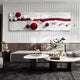 A modern living room features the Lustra Red & White 3D Wood Relief Wall Art by Giant Sculptures, showcasing red and white spheres on wavy panels. A gray sectional encircles two round coffee tables with books and decor, while a small sculpture is placed on a gold-accented side table.