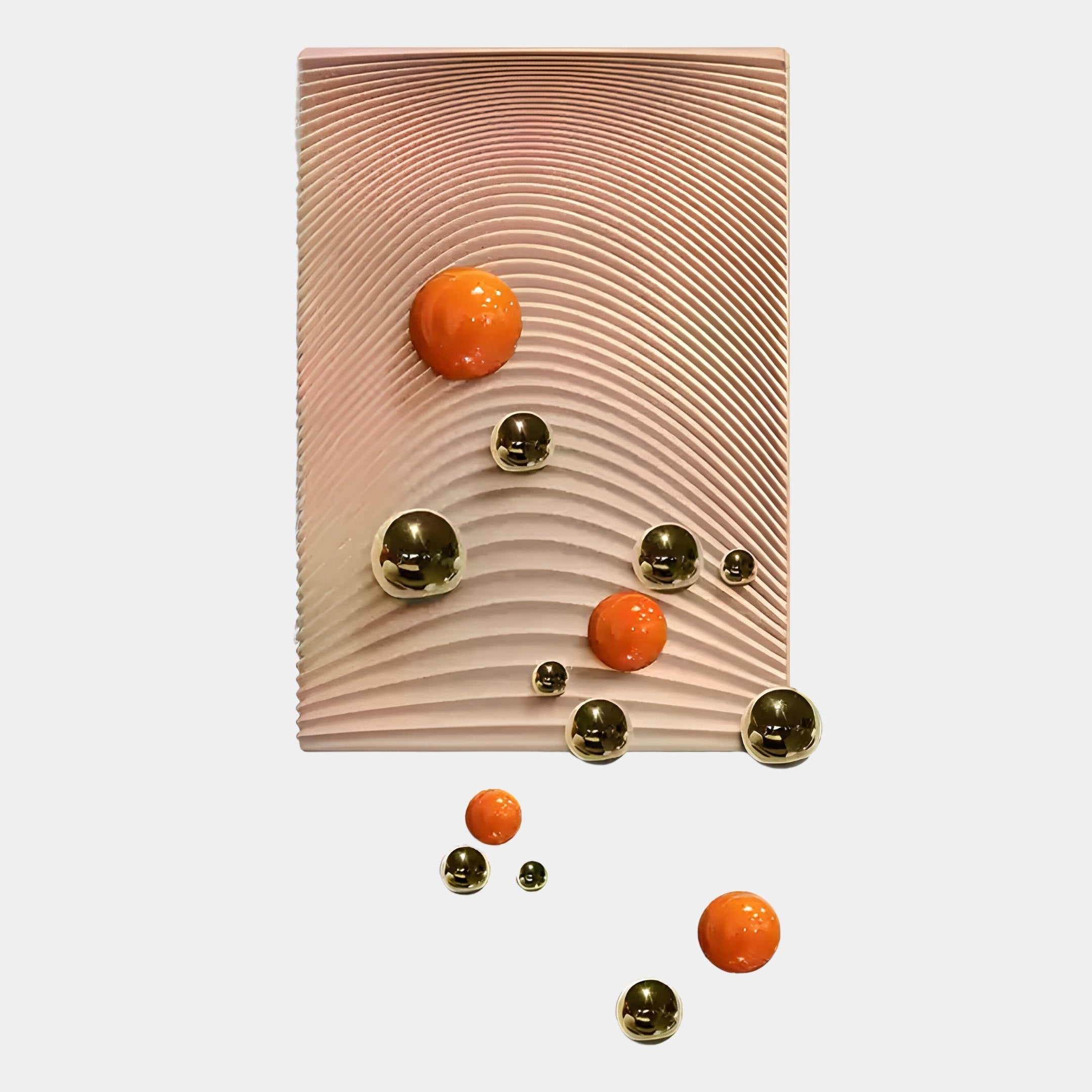 The Sphera Amber 3D Wood Relief Wall Art With Gold & Orange Metal Ball by Giant Sculptures features wavy grooves and displays gold and orange metal balls, some on the relief panel and others floating below on a light background.