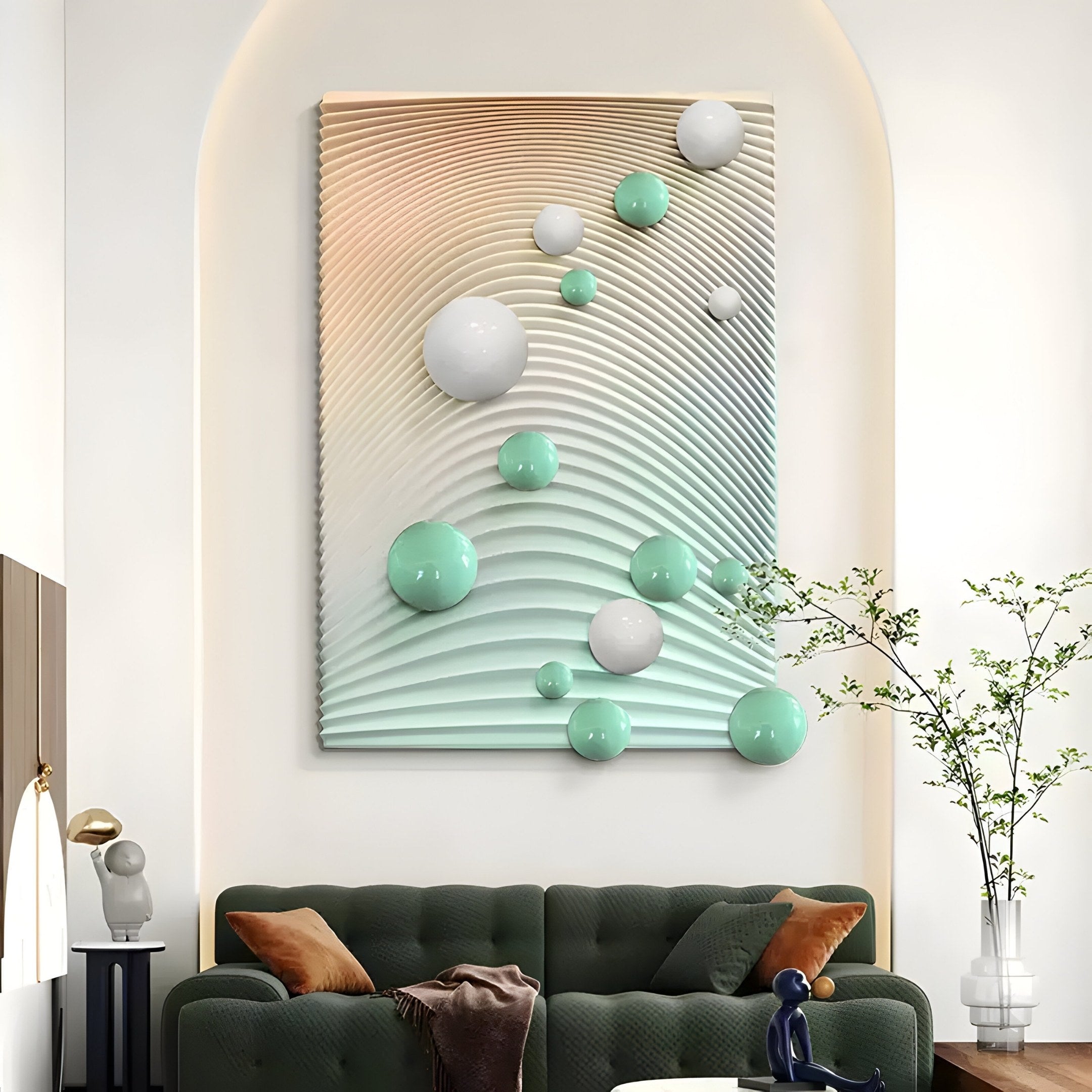 A chic living room features a dark green couch with colorful cushions. The highlight is the Sphera Gradient 3D Wood Relief Wall Art with Mint & White Metal Ball by Giant Sculptures. A side table vase with branches enhances the modern aesthetic.