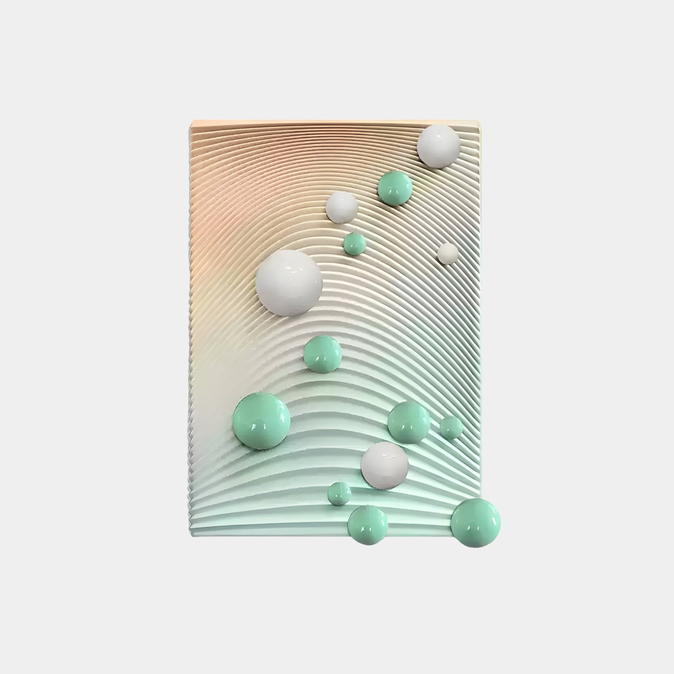 The Sphera Gradient 3D Wood Relief Wall Art by Giant Sculptures is a contemporary rectangular centerpiece featuring a wavy, textured surface in pastel hues. Mint and white metal balls of various sizes enhance the 3D effect against the neutral background.