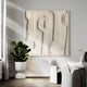 In a modern dining room, the Terravura Square Sandstone I 3D Wood Relief Wall Art by Giant Sculptures takes center stage with its textured design. Below, a white round table is encircled by sleek armless chairs. A leafy plant in a sandstone finish pot brings greenery to the minimalist setup.