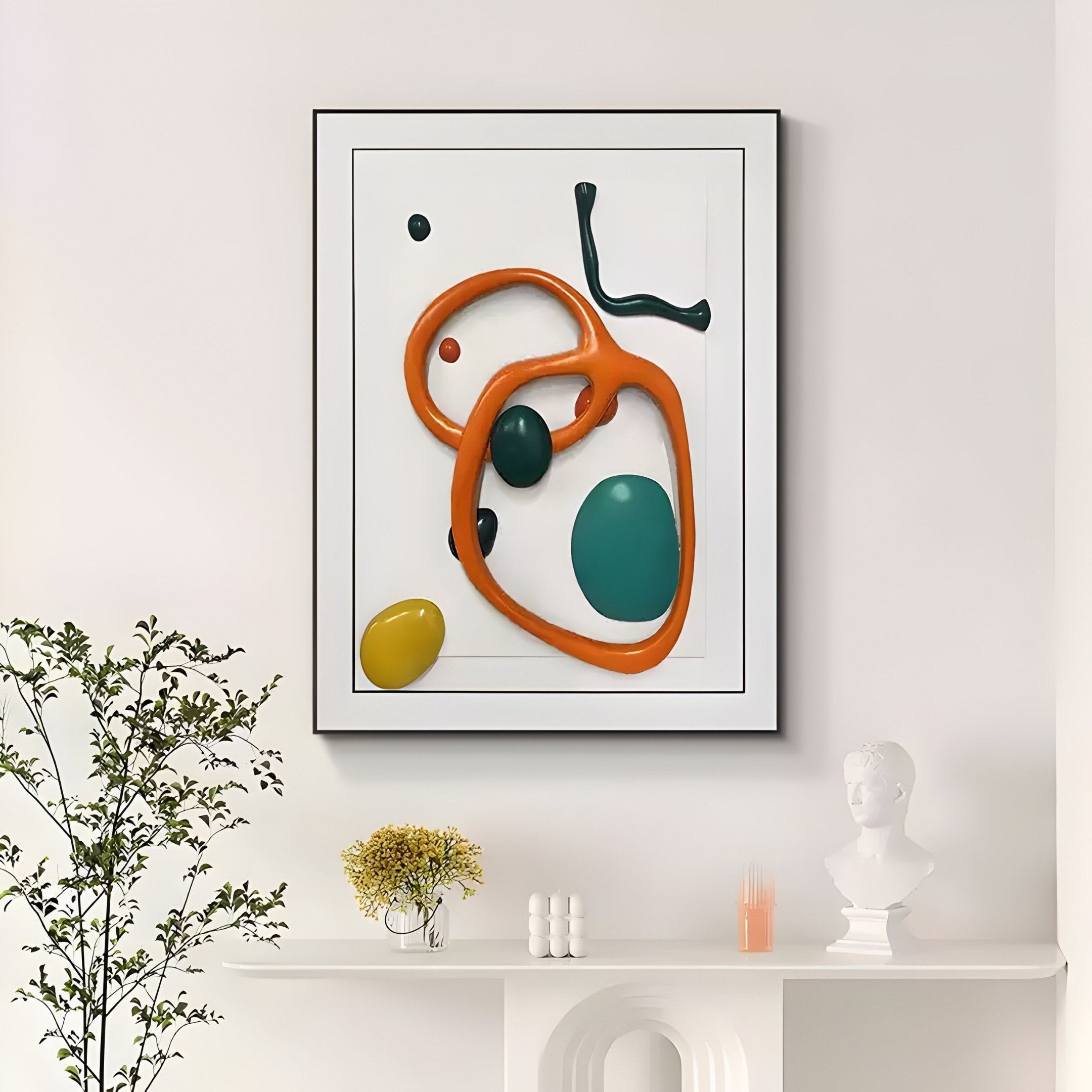 In a white room, the Vitrus Orange & Green Abstract Wood Embossed 3D Wall Art by Giant Sculptures adds boldness with its vibrant colors. Below it, a shelf displays a bust, plant, small objects, and an embossed wood design. A potted plant enhances the artistic space on the left side.