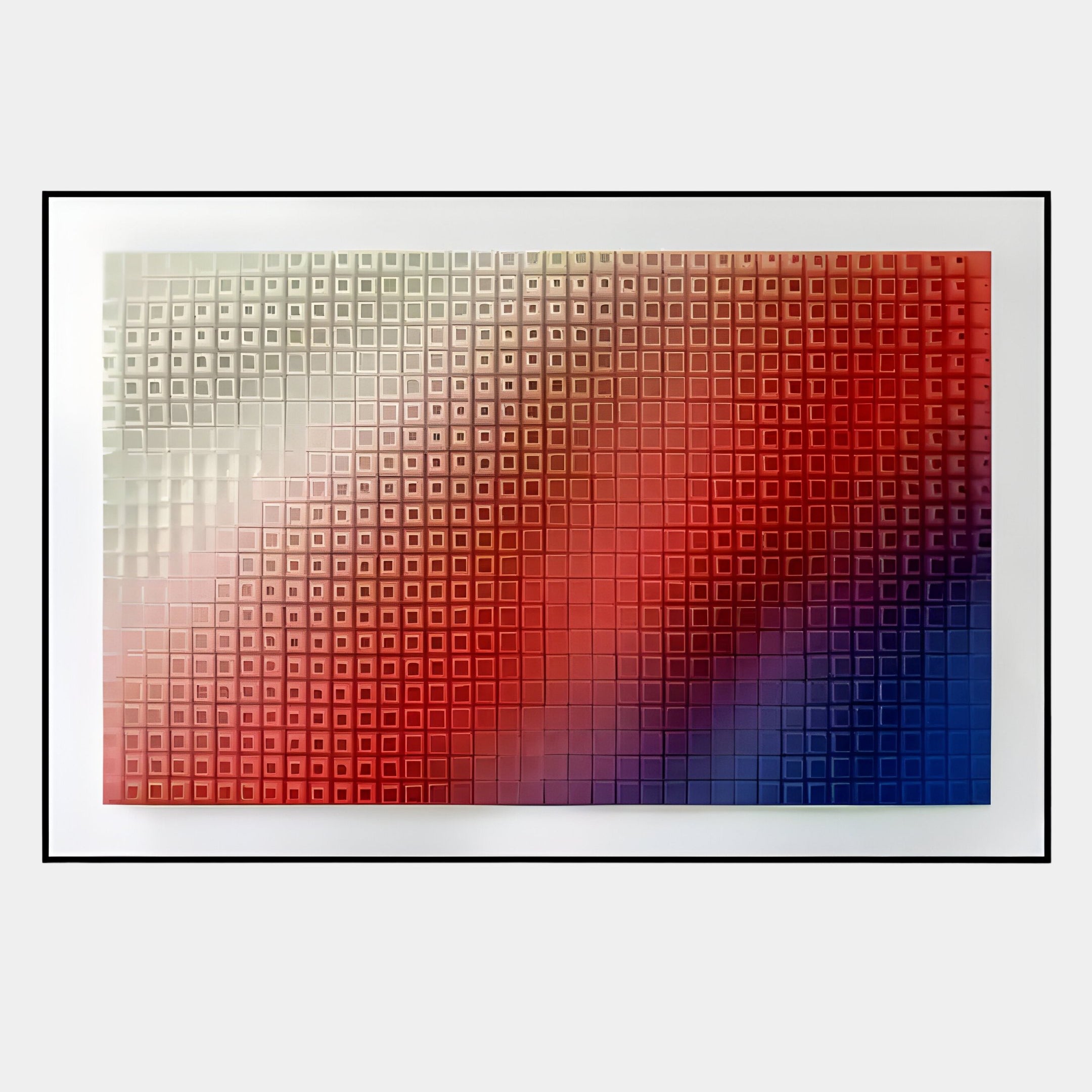 The Elytrum Red & Blue Grid Gradient Hand-Painted Wood Relief 3D Wall Art by Giant Sculptures features a grid of raised square tiles, artfully transitioning from white to red to blue, framed with a sleek black border for a modern look.