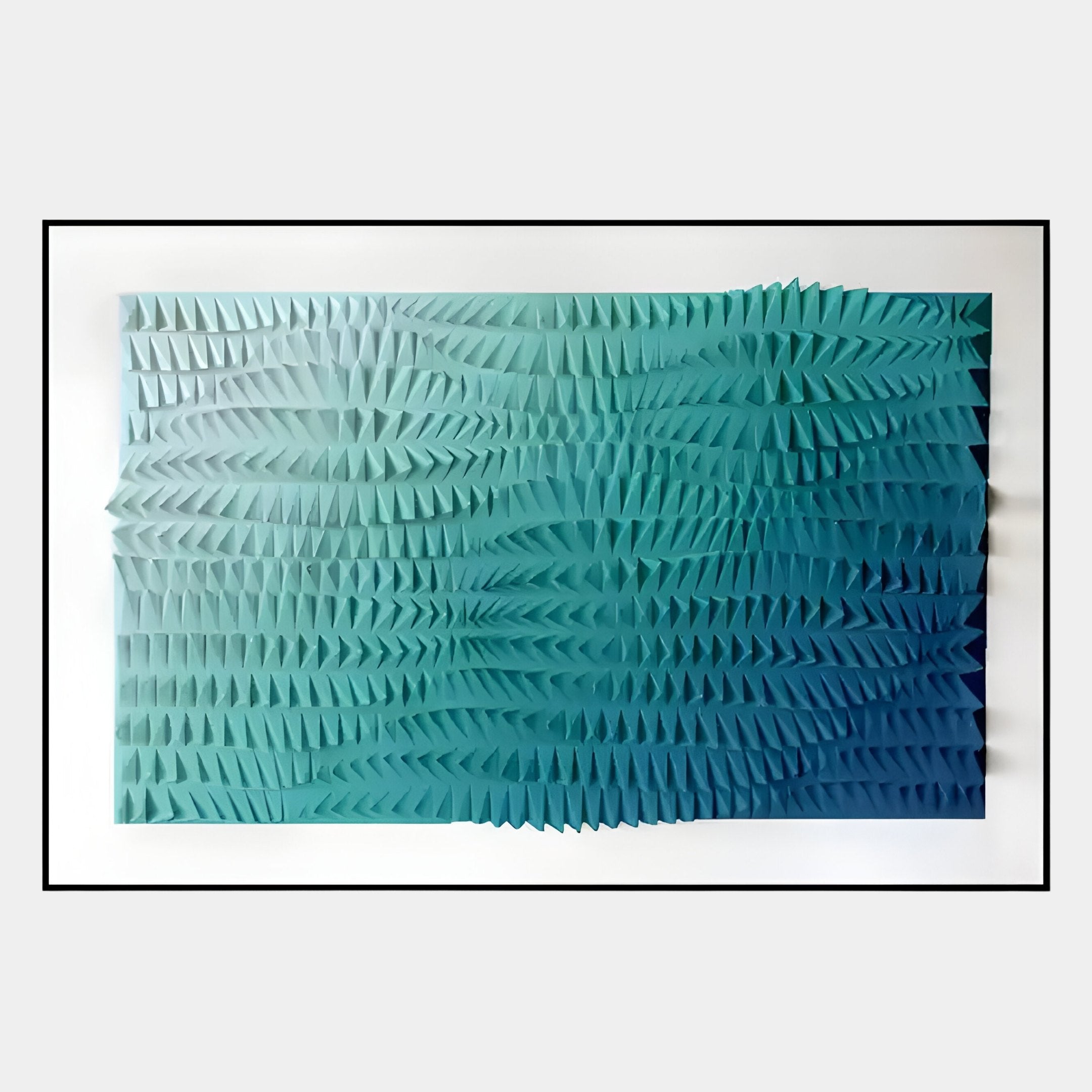 The Elytrum Blue Gradient Hand-Painted Wood Relief 3D Wall Art by Giant Sculptures showcases a rectangular grid of blue-green triangular spikes with a smooth gradient from light to dark, creating a dynamic wave-like effect.