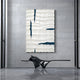 Striata White & Blue Wood Carving 3D Wall Art by Giant Sculptures features wave-like, wavy white panels and dark blue lines on a gray tiled wall. Below it, theres a sleek black bench with smooth curves.