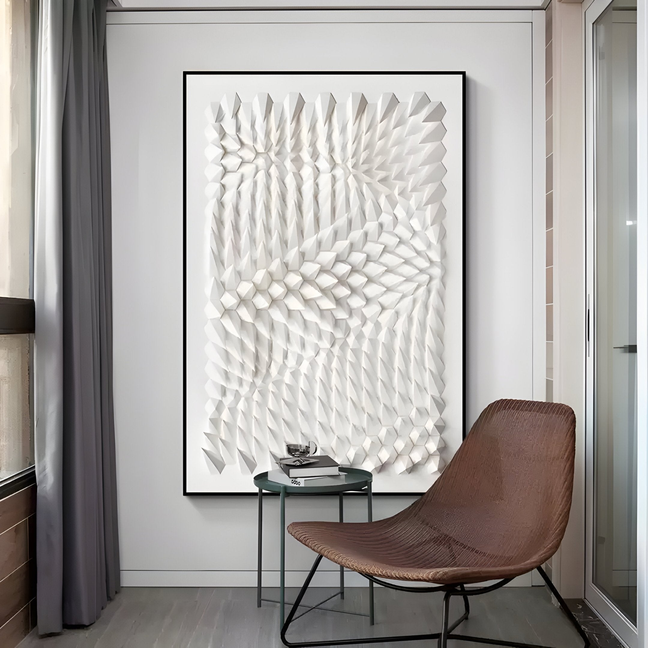 A contemporary room showcases a Giant Sculptures Elorium White Concentric Hand-Painted Wood Relief 3D Wall Art, complementing a modern brown lounge chair and small gray side table with decor. Floor-to-ceiling curtains frame a window on the left, enhancing the minimalist design.