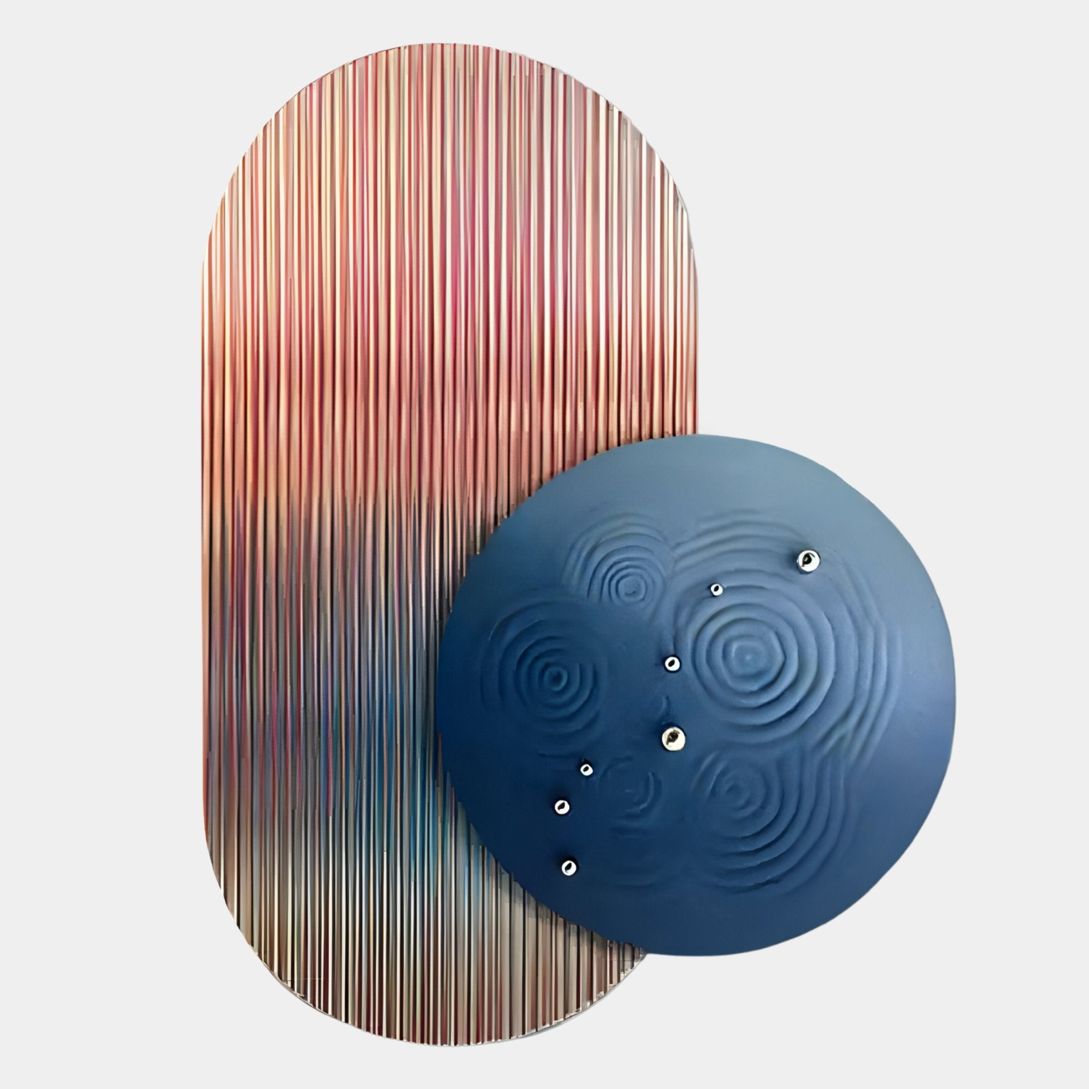 The Embera Abstract Circle Multicolour Gradient 3D Wall Art by Giant Sculptures features a blue textured circular shape with sculptural ripples and metallic dots, set before an oval with vertical multicolour gradient stripes on a light gray background.
