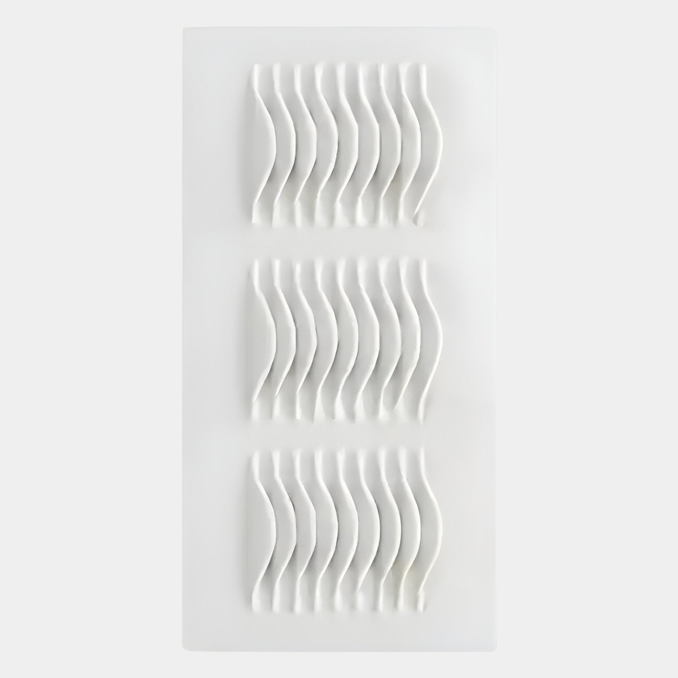 The Ondara Wave White Vertical Wood Relief 3D Wall Art by Giant Sculptures features three wavy, raised rows on a white rectangular panel for a striking, modern textured display.