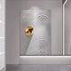 The Ondella Gold Ripple III Sandstone Wood Relief 3D Wall Art by Giant Sculptures showcases a textured white panel with concentric circles, akin to water ripples, highlighted by a reflective golden accent in the upper left, perfect for adding a contemporary touch to any minimalist wall.