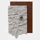 The Calidora Terra Sculpted Textured 3D Relief Wall Art by Giant Sculptures features a wavy-edged white sheet with a shiny metallic sphere, layered over a flat brown rectangle for a striking look.