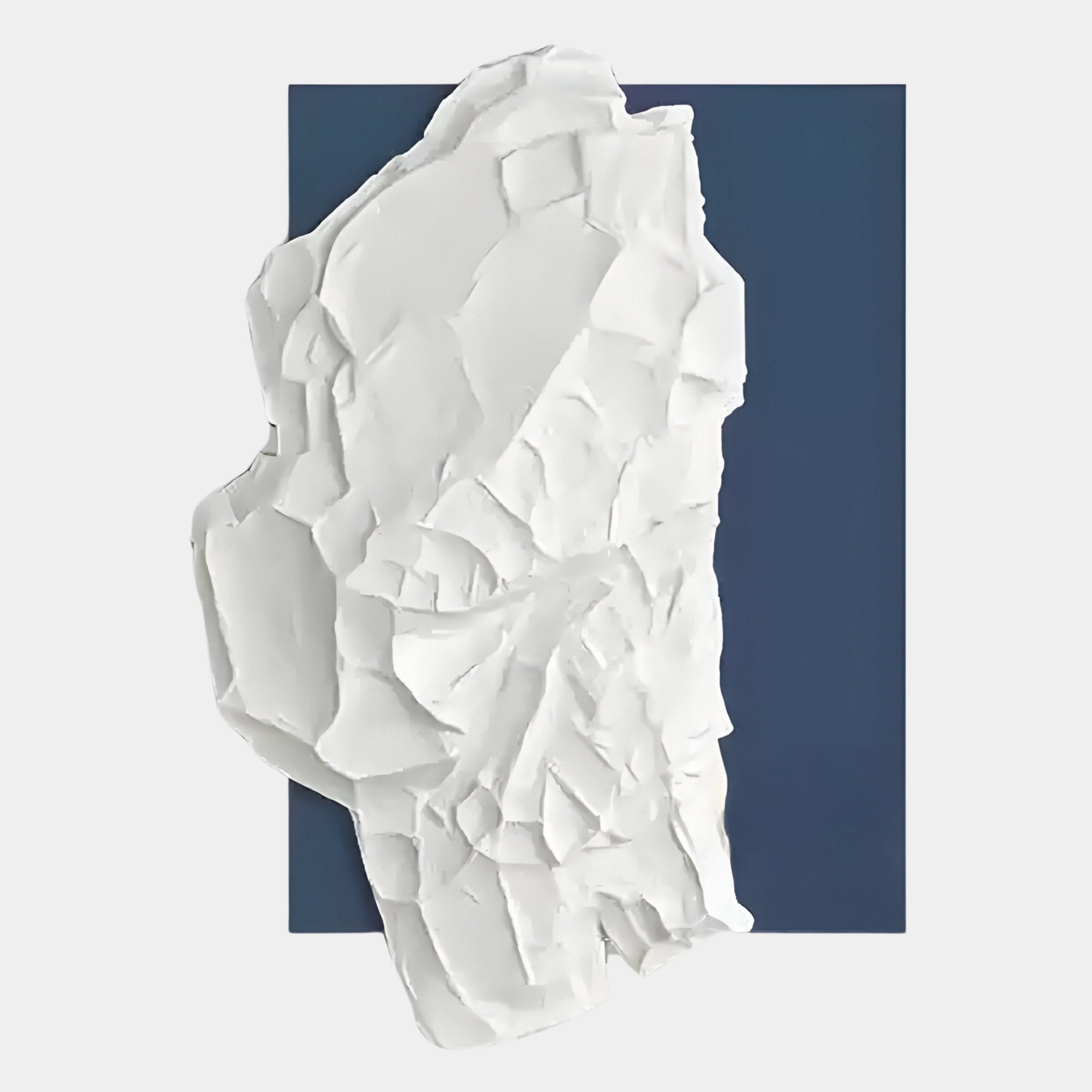 The Veritas White & Blue Abstract Wood Relief 3D Wall Art by Giant Sculptures features a textured white plaster form set against a dark blue background, offering modern decor a bold contrast of organic shape and solid color.
