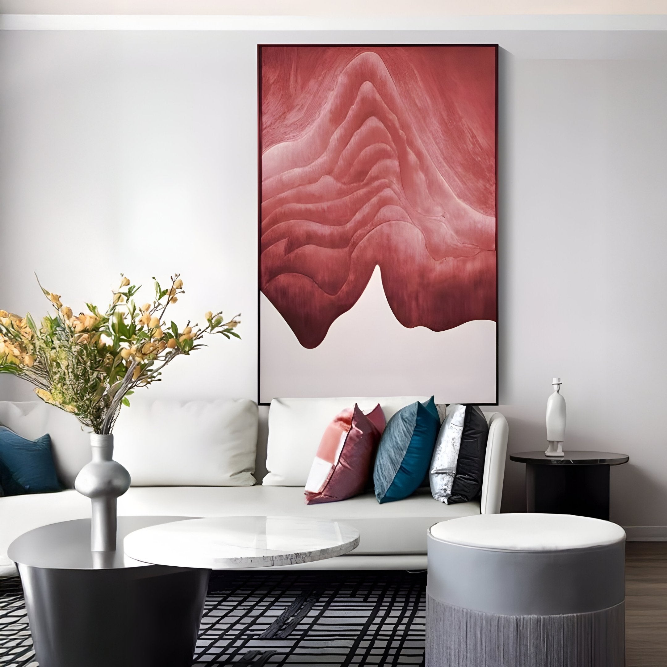 A modern living room with a white sofa and round coffee table showcases the Celoria Rose Ember Wood Carving 3D Wall Art by Giant Sculptures—a large abstract red and white mountain piece above the couch—complementing the Contemporary Interiors style.