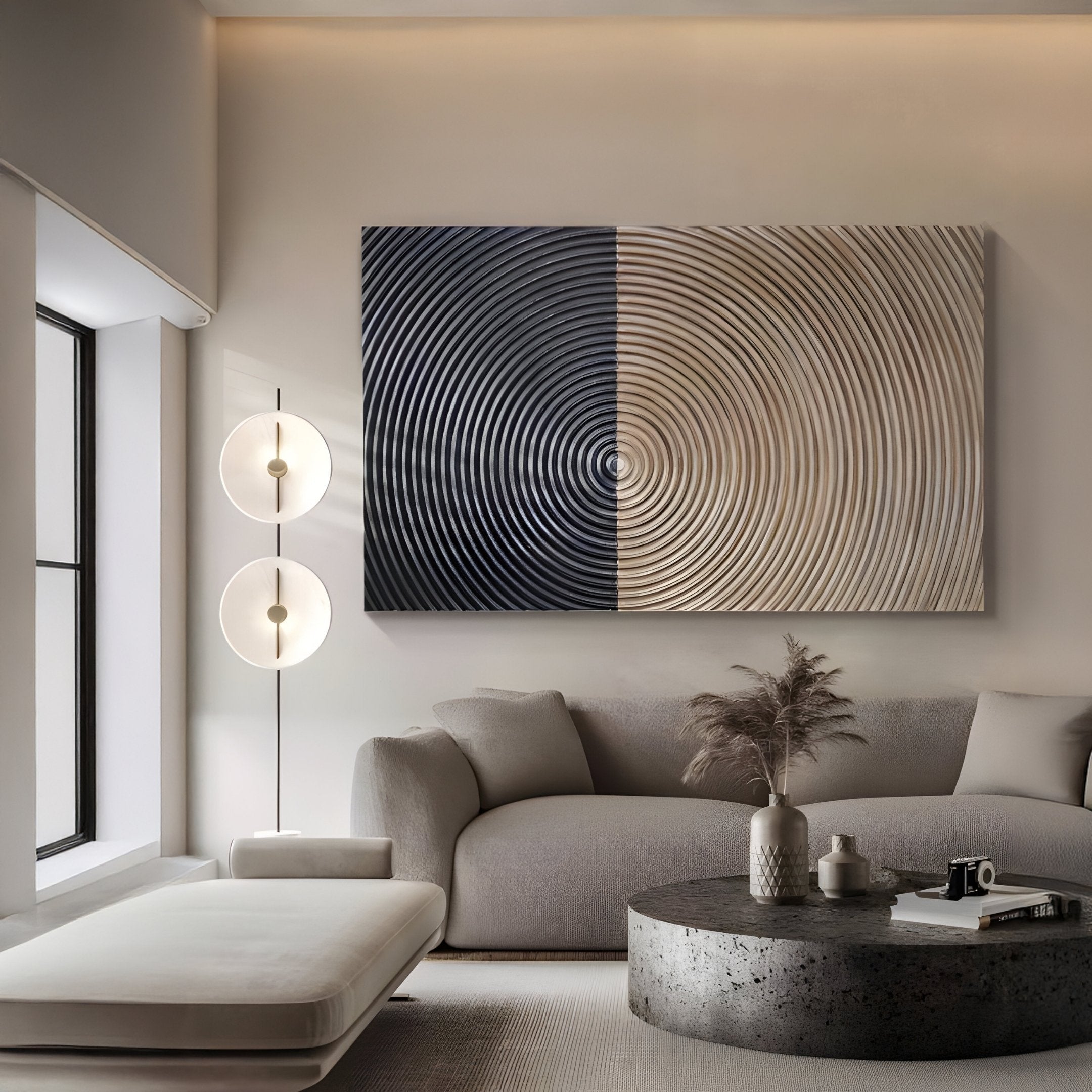A modern living room features a light grey sofa, matching ottoman, round coffee table, and tall floor lamp. Above the sofa hangs Giant Sculptures Artura Beige & Black Hand-Painted 3D Relief Wall Art, enhancing the calm Wabi-Sabi-inspired decor.