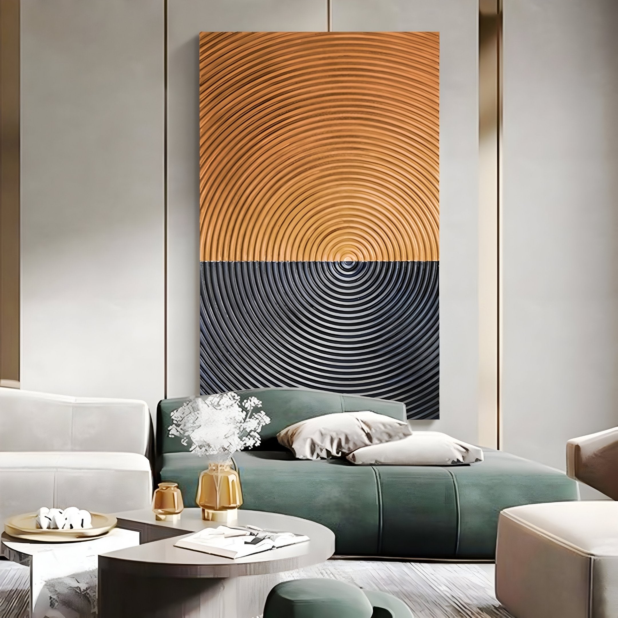 A modern living room includes a green sectional sofa with pillows, a white vase with flowers on a small table, and Giant Sculptures’ Artura Honey & Black Hand-Painted 3D Relief Wall Art, featuring bold abstract concentric circles for minimalist style.