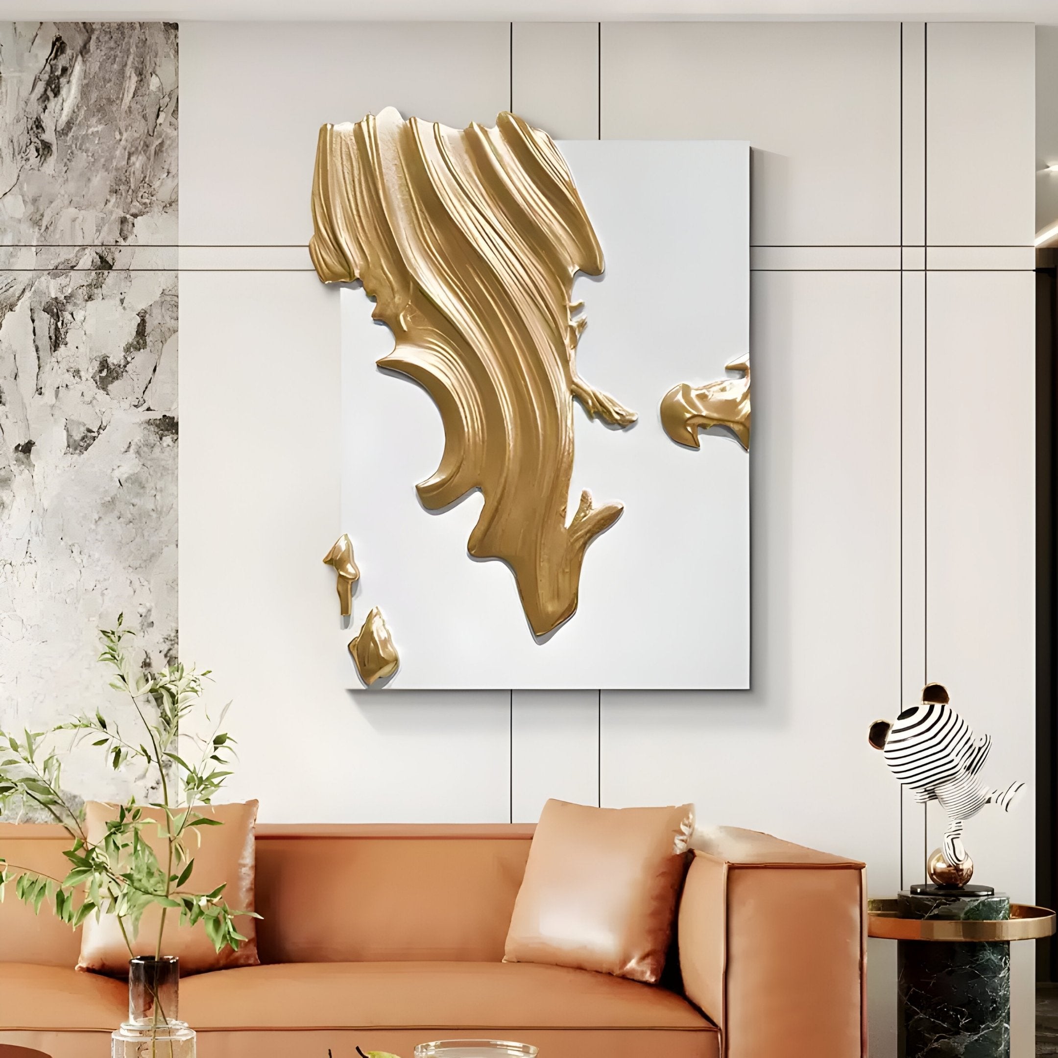 A modern living room features a tan leather sofa, glass coffee table, and the Opulina White & Gold I Wood Relief 3D Wall Art by Giant Sculptures. Marble wall accents, sculptural art details, and a small plant complete this stylish space.