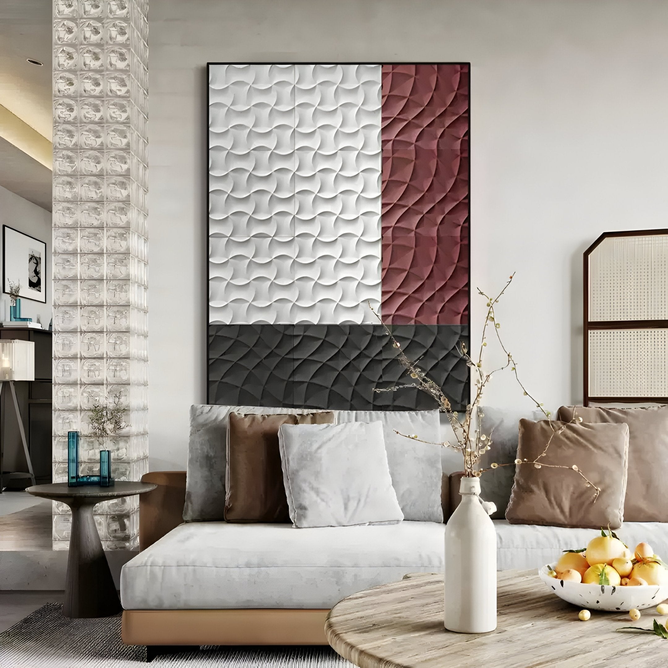 A modern living room with a light gray sofa, beige and brown pillows, a round coffee table with a white vase and branches, and the Trelume White, Black & Rose Wavy Wood Relief 3D Wall Art by Giant Sculptures.