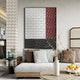 A modern living room with a light gray sofa, beige and brown pillows, a round coffee table with a white vase and branches, and the Trelume White, Black & Rose Wavy Wood Relief 3D Wall Art by Giant Sculptures.
