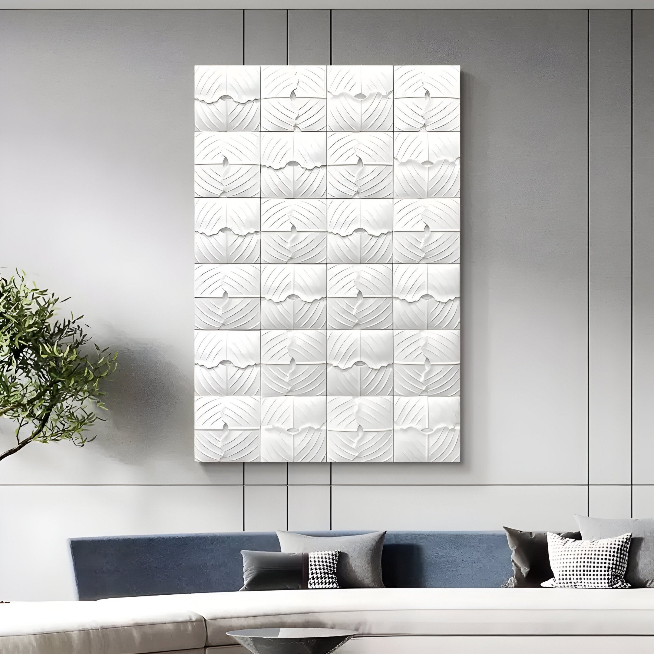 A modern living room features the Vellura White Textured Wood Relief 3D Wall Art by Giant Sculptures above a blue and white sofa with assorted pillows; Minimalist Abstraction is accentuated by a green plant on the left.