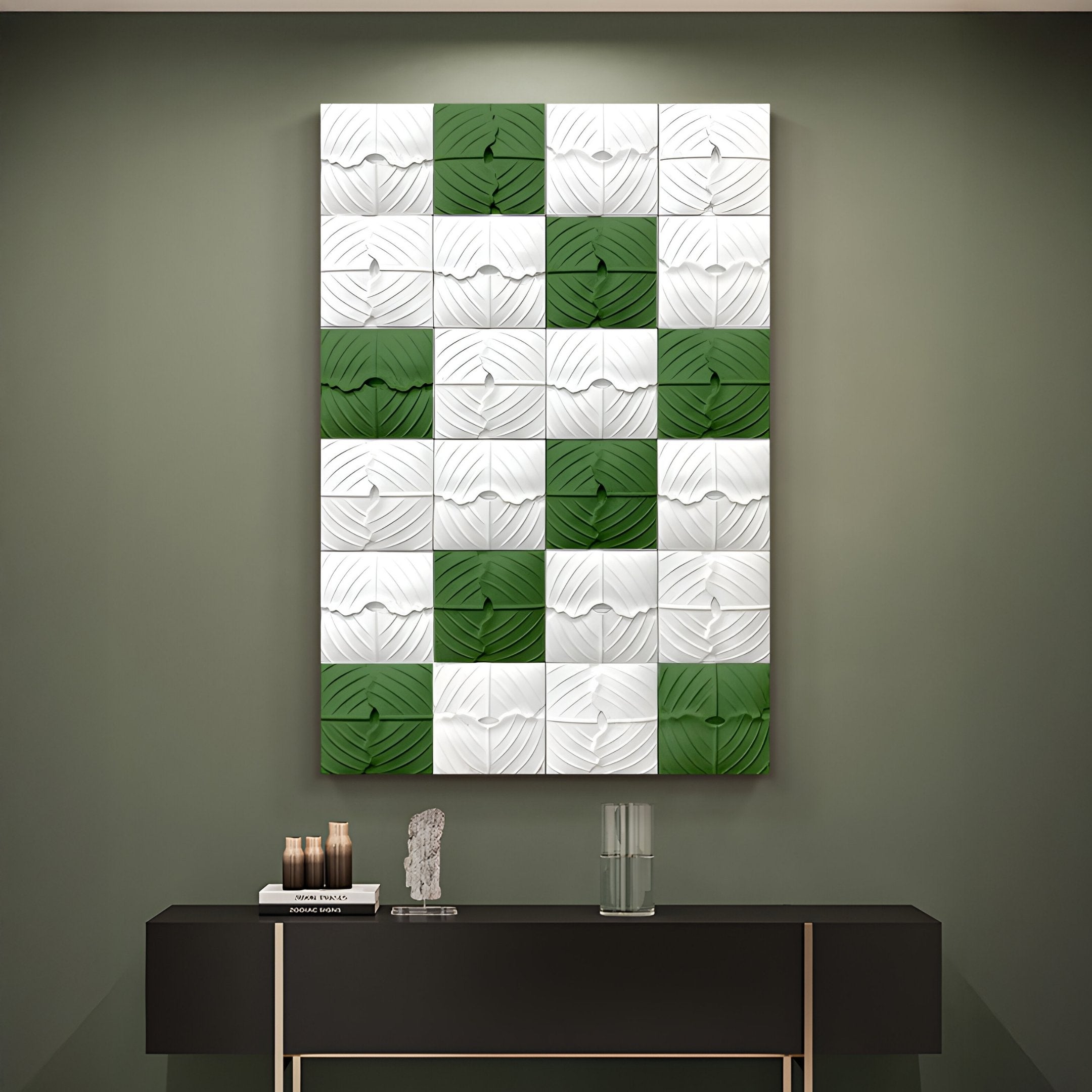 The Vellura White & Green Textured Wood Relief 3D Wall Art by Giant Sculptures hangs above a sleek black console table adorned with books, a small sculpture, and a glass of water.