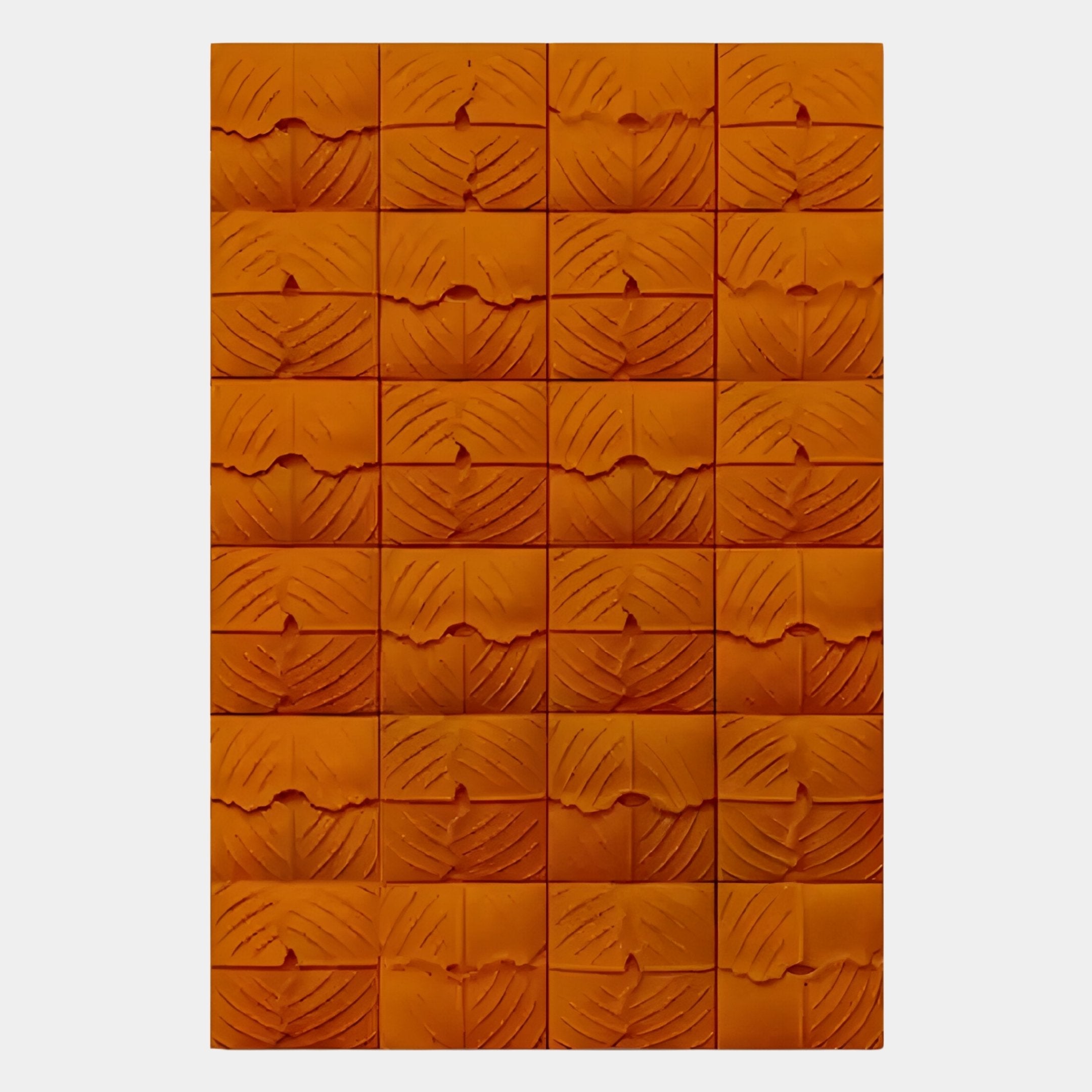 The Vellura Orange Textured Wood Relief 3D Wall Art by Giant Sculptures features a grid of abstract, leaf-patterned blocks in six rows and five columns—ideal as unique, modern wall decor.
