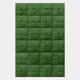 The Vellura Green Textured Wood Relief 3D Wall Art by Giant Sculptures features 25 hand-carved green wooden tiles with curved and diagonal engravings, forming a leaf-like abstract pattern on a light background.