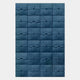 The Vellura Blue Textured Wood Relief 3D Wall Art by Giant Sculptures features a grid of blue, square tiles with abstract patterns, forming a striking geometric design against a white background.