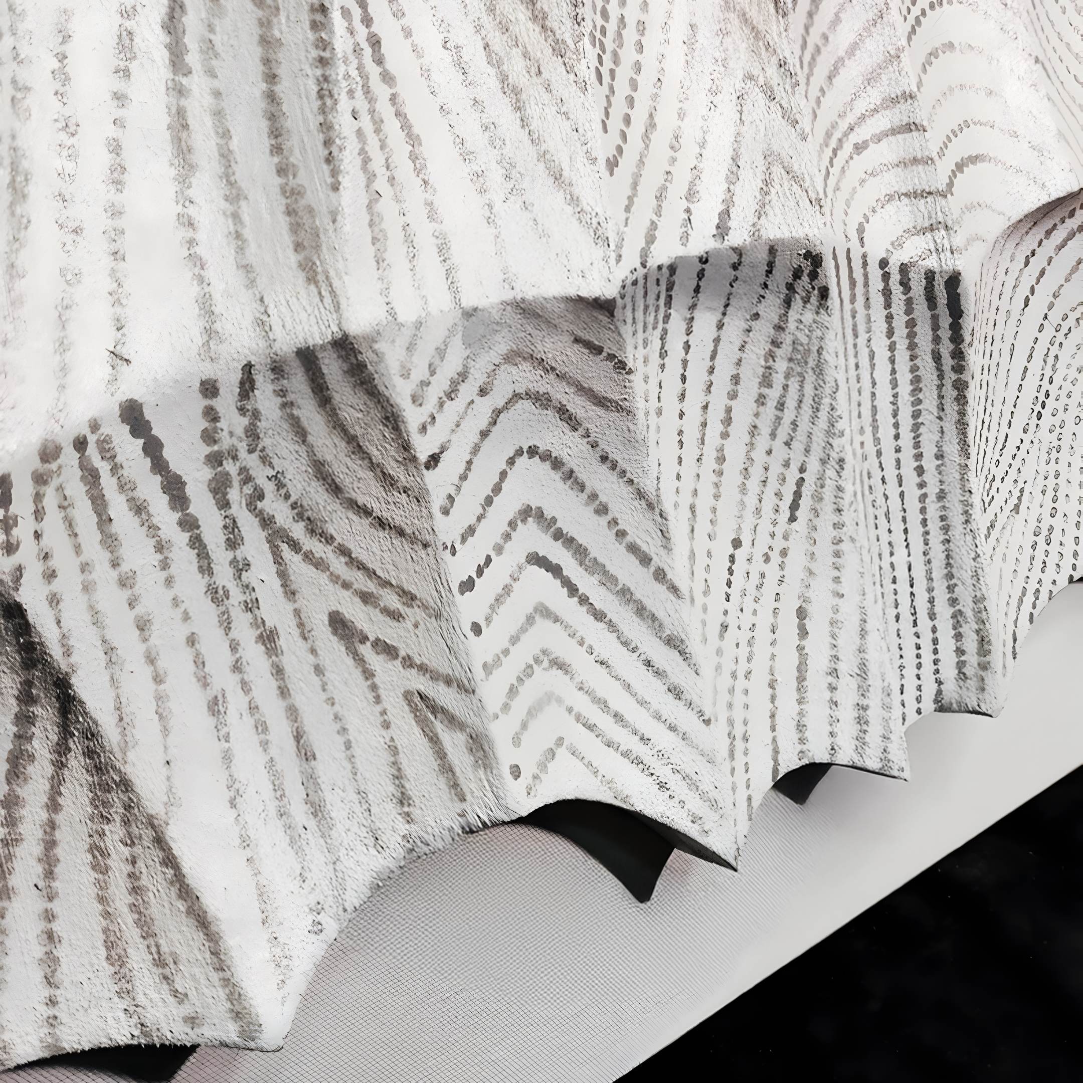 Close-up of Novara White I Hand-Painted Wood Relief 3D Wall Art by Giant Sculptures, featuring white, folded wood with zigzag and dotted gray details that create a textured, layered look against a soft background.
