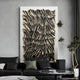 A modern living room features a black sofa with decorative pillows, a marble coffee table, and the Novara Zebra II Hand-Painted Wood Relief 3D Wall Art by Giant Sculptures above the sofa. A tall plant on the right complements this striking focal piece.