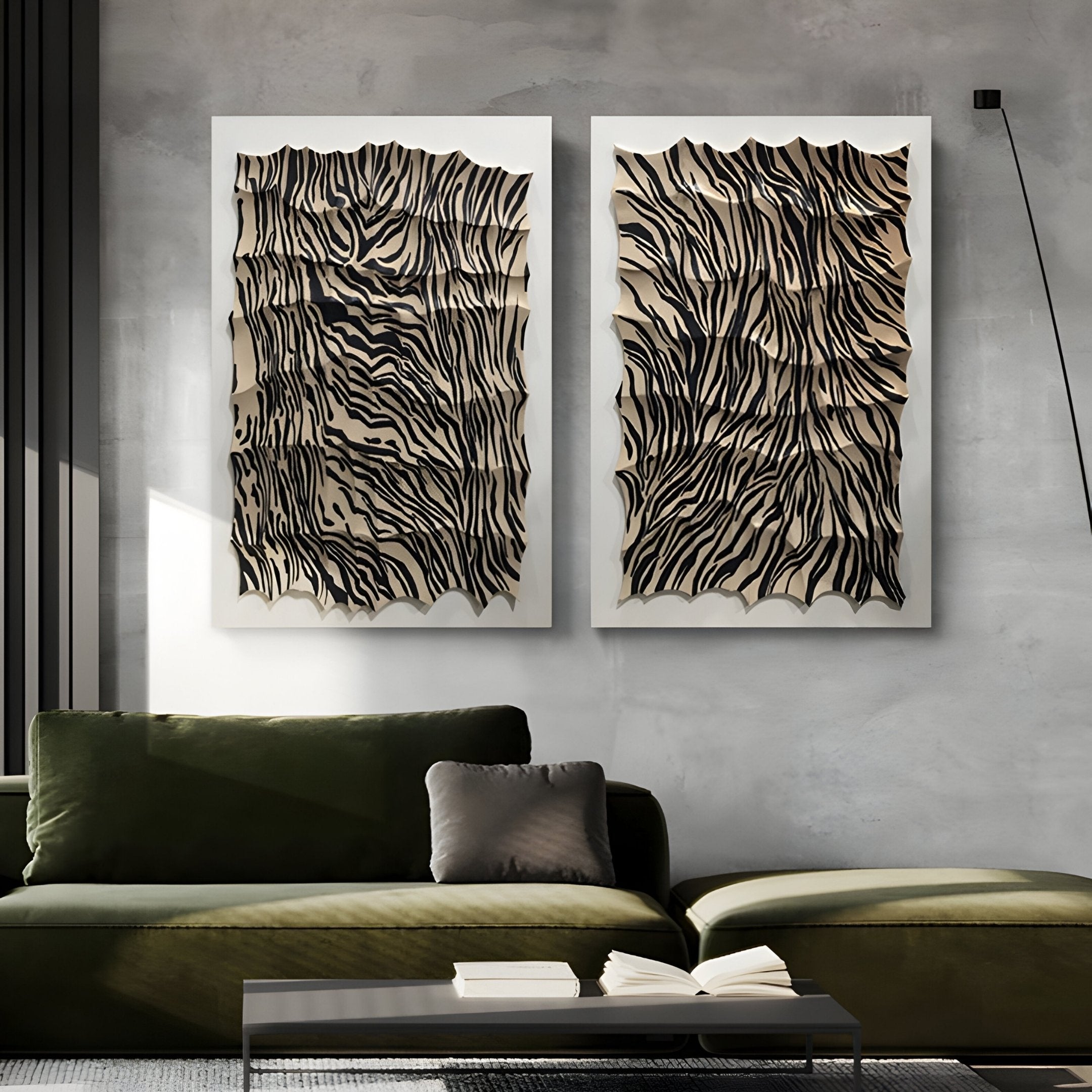 A modern living room with a dark green velvet sofa, a low white coffee table with an open book, and two Giant Sculptures Novara Zebra II Hand-Painted Wood Relief 3D Wall Art pieces adding sculptural dimension to the gray concrete wall.