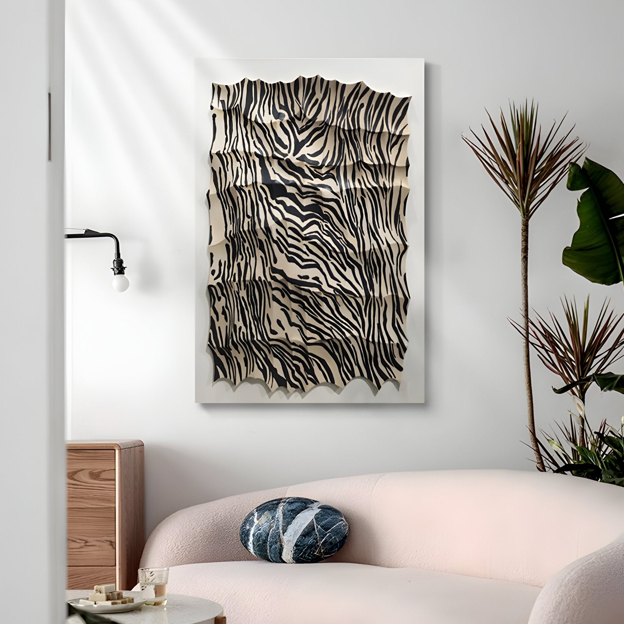 A modern living room features a light pink sofa, round decorative pillow, potted plant, and Giant Sculptures Novara Zebra III Hand-Painted Wood Relief 3D Wall Art—an abstract, animal print-inspired masterpiece.