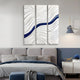 A modern bedroom features a gray bed with blue and white bedding, a blue ottoman, a bedside table with a blue vase, and the Evolva 3-Panel White & Blue Wood Relief 3D Wall Art by Giant Sculptures above the bed.