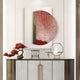 A minimalist sideboard with gold handles features a red bonsai, a small decorative chair, and Artevia Red & White Geometric Wood Relief 3D Wall Art by Giant Sculptures above. A white bird sculpture rests gracefully on a metal ring stand.