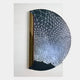 The Artevia Blue & White Geometric Wood Relief 3D Wall Art by Giant Sculptures showcases a half-circle with a white mesh fading to blue, set on a textured rectangular background with vertical lines and a central metallic cylinder.