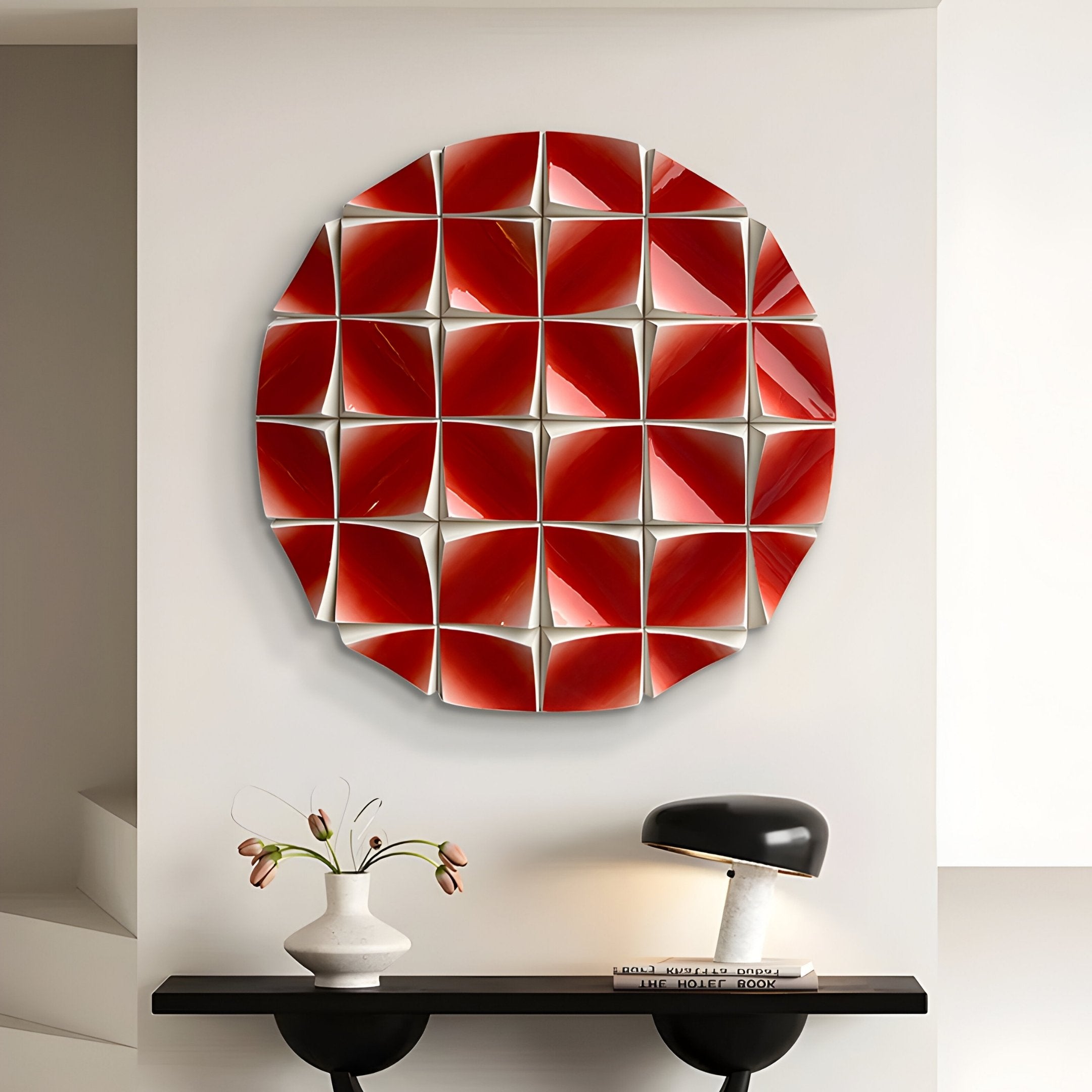 The Incalia Red Circular Geometric Wood Relief 3D Wall Art by Giant Sculptures hangs above a black console topped with a white vase of flowers, stacked books, and a sleek black modern lamp.