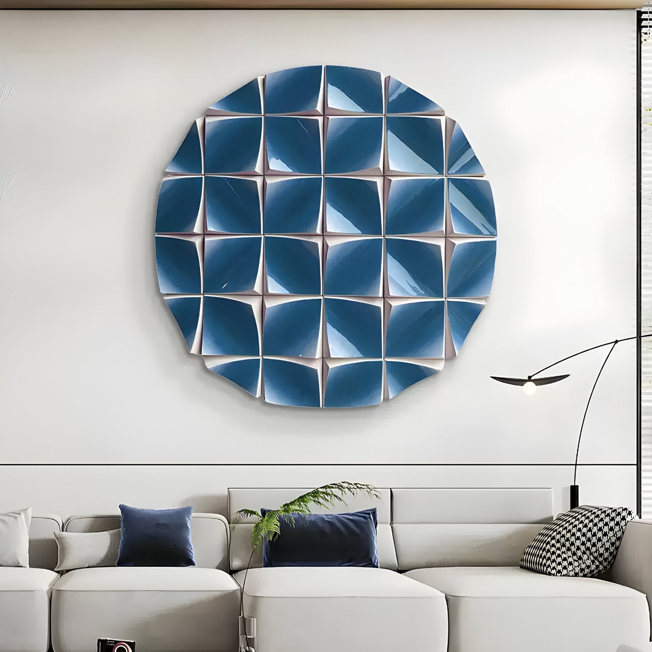 A modern living room featuring a white sectional sofa, blue and gray accent pillows, a minimalist floor lamp, and the Incalia Blue Circular Geometric Wood Relief 3D Wall Art by Giant Sculptures for bold contemporary style.