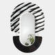 The Arcus Black & White Zebra Stripes Mirror 3D Wooden Wall Art by Giant Sculptures features a bold black and white striped top, a solid textured black bottom, and reflects green leafy plants—perfect as distinctive contemporary décor.