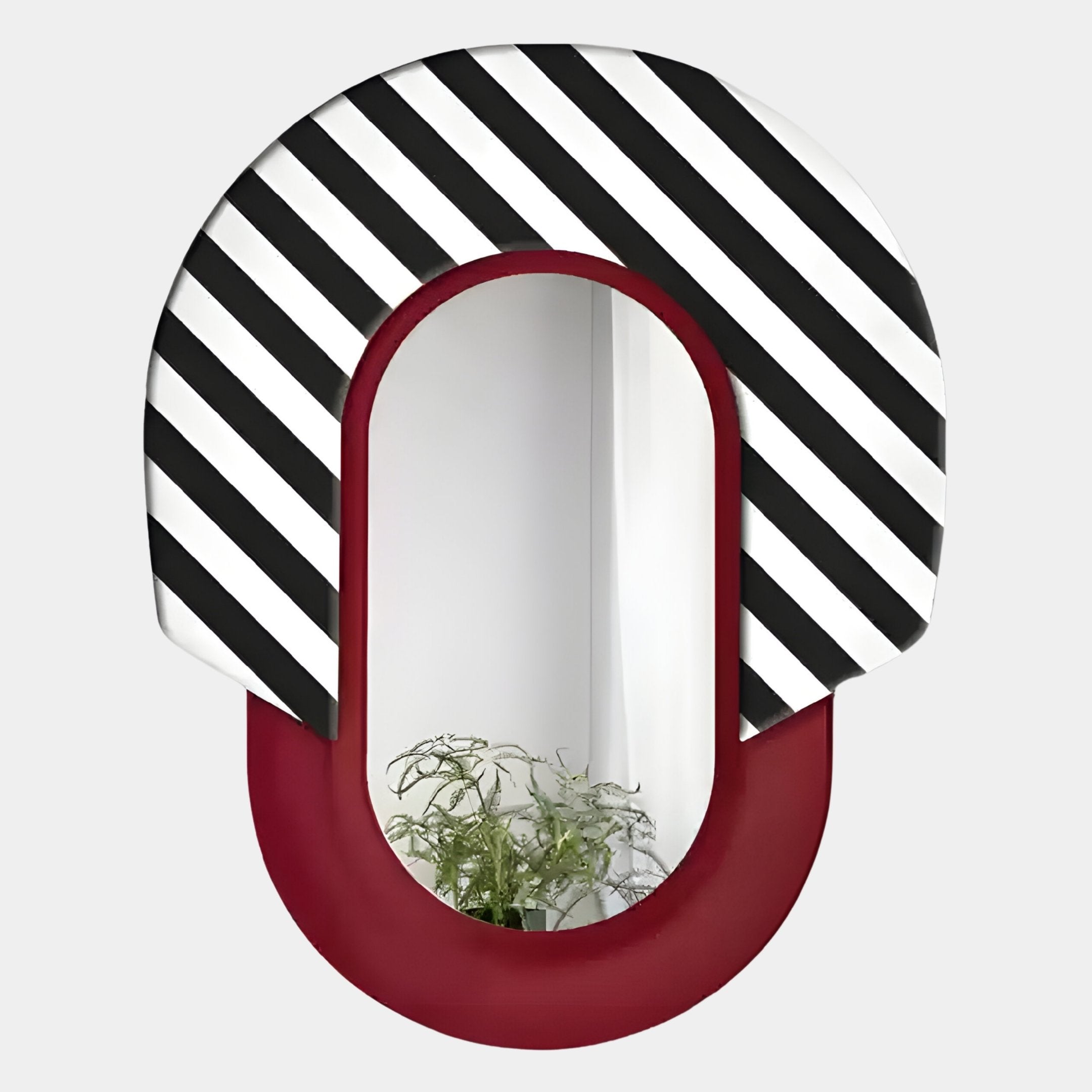The Arcus Red & Black-White Striped Mirror 3D Wooden Wall Art by Giant Sculptures features a bold, maroon and striped frame, reflecting greenery—ideal for adding flair to contemporary interiors as wall art or home decor.
