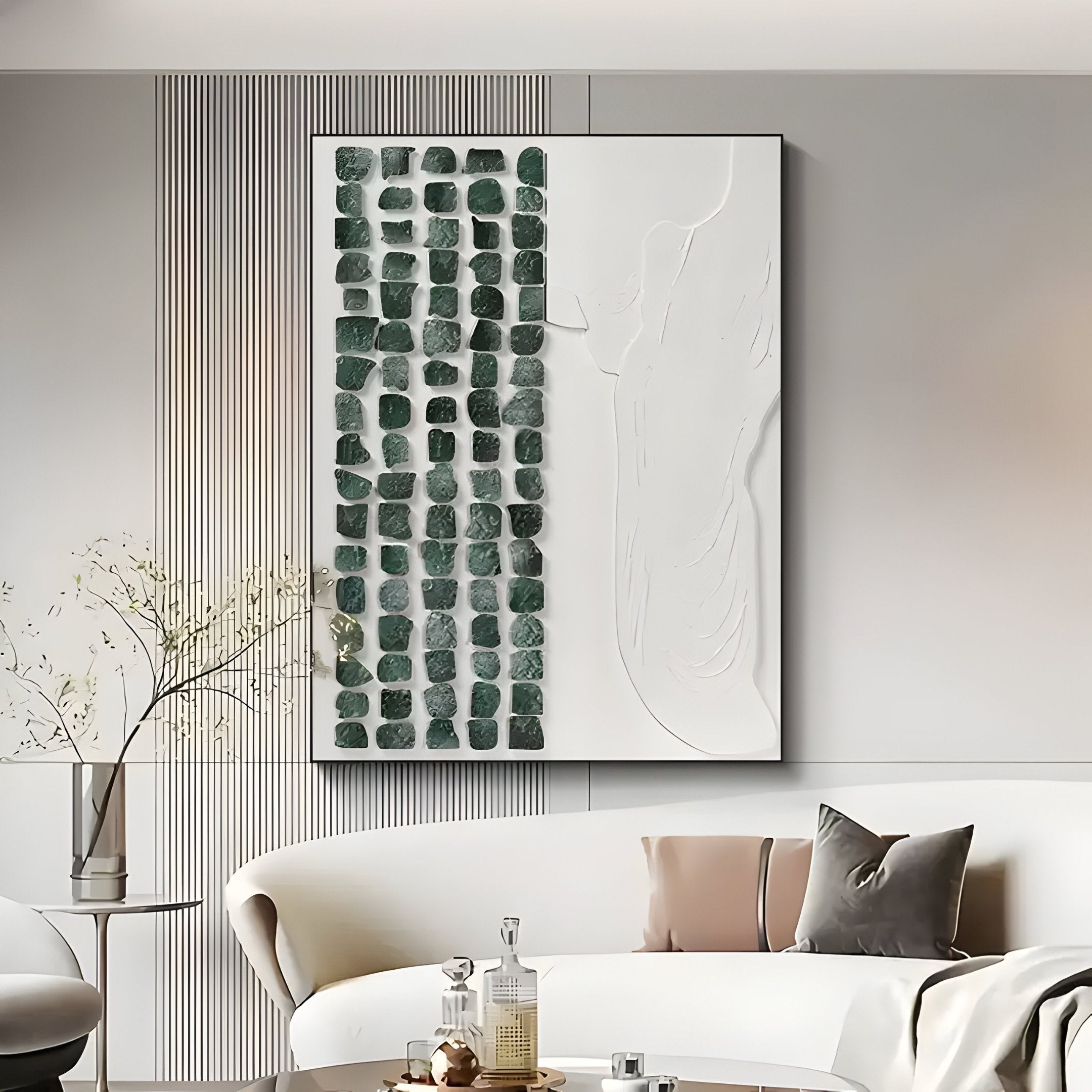 A modern living room showcases a sleek white couch with pillows, highlighted by the Aestilis Green & White Mosaic Wood Carving 3D Wall Art by Giant Sculptures, which features dark green squares and smooth white areas. A small vase with branches on the table completes the look.