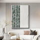 A modern living room showcases a sleek white couch with pillows, highlighted by the Aestilis Green & White Mosaic Wood Carving 3D Wall Art by Giant Sculptures, which features dark green squares and smooth white areas. A small vase with branches on the table completes the look.